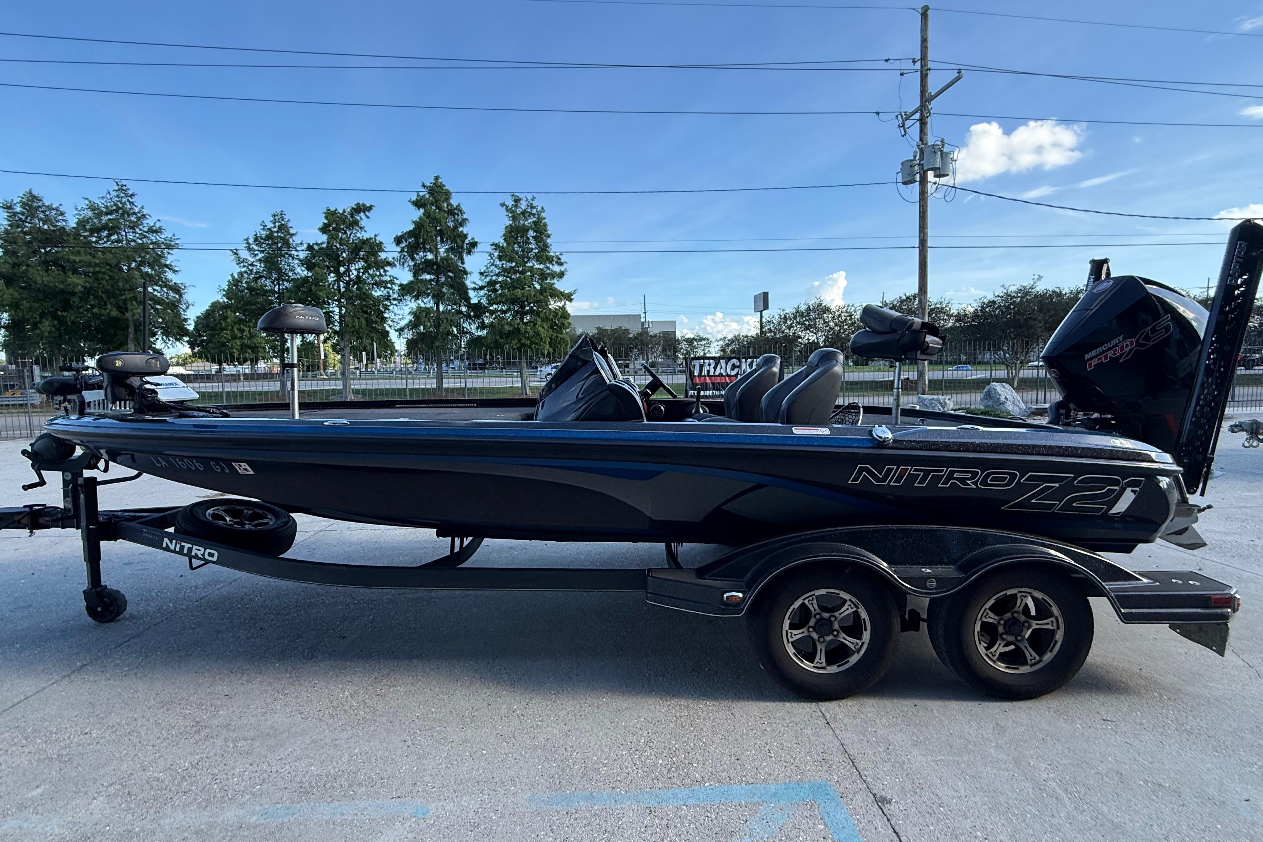 2018 Nitro Z21 boat on trailer, parked outdoors under clear blue sky.