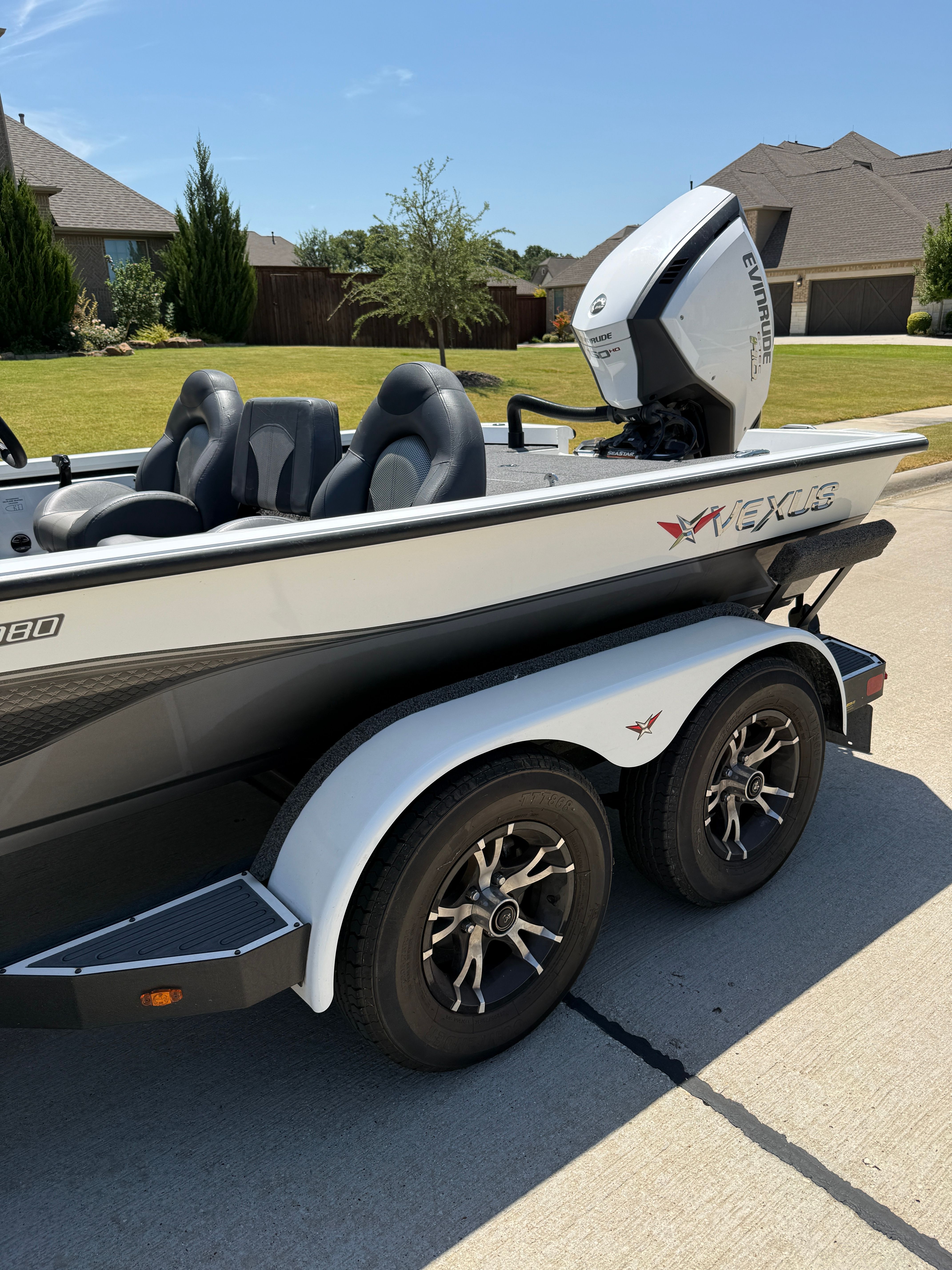 A 2019 Vexus AVX1980 boat on a trailer in a residential area.