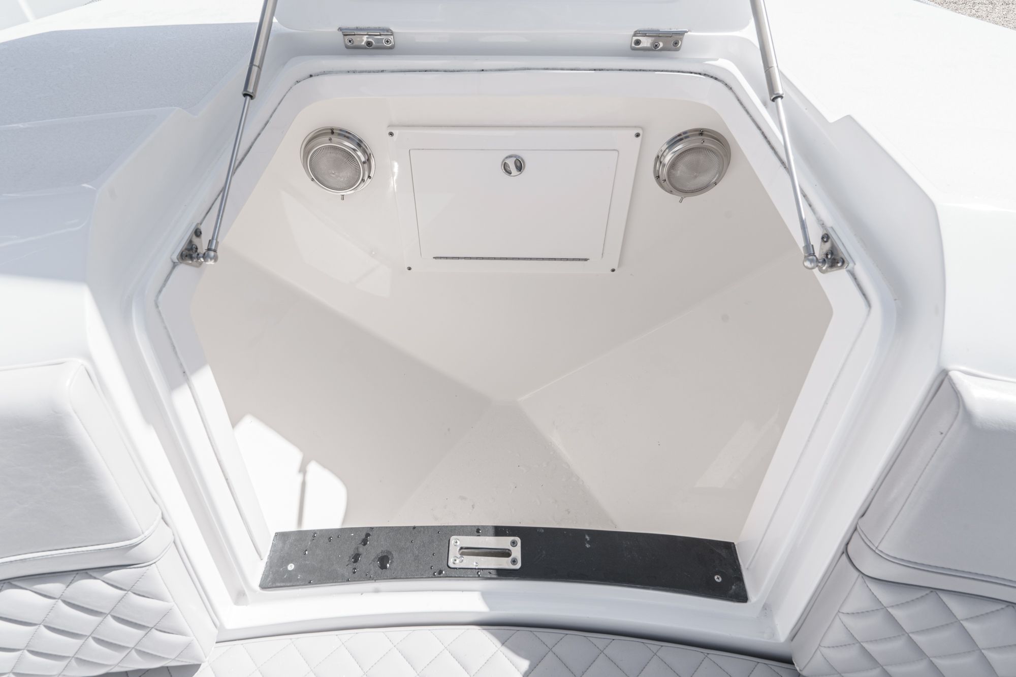 Intrepid 375 NOMAD 2021 storage compartment with cushioned seating.