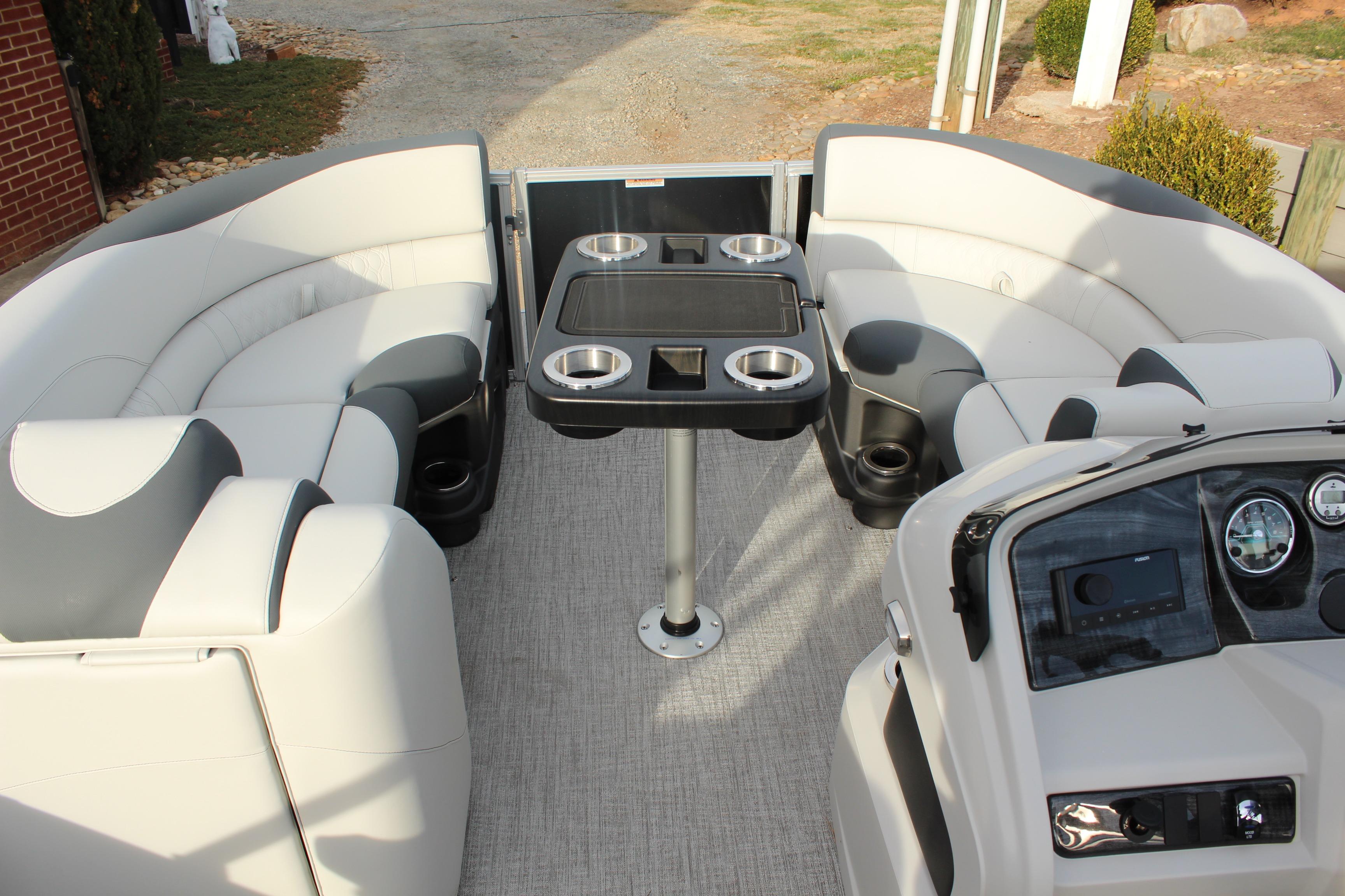 2026 Tahoe Pontoon LTZ interior with plush seating and central table, ideal for leisure cruising.