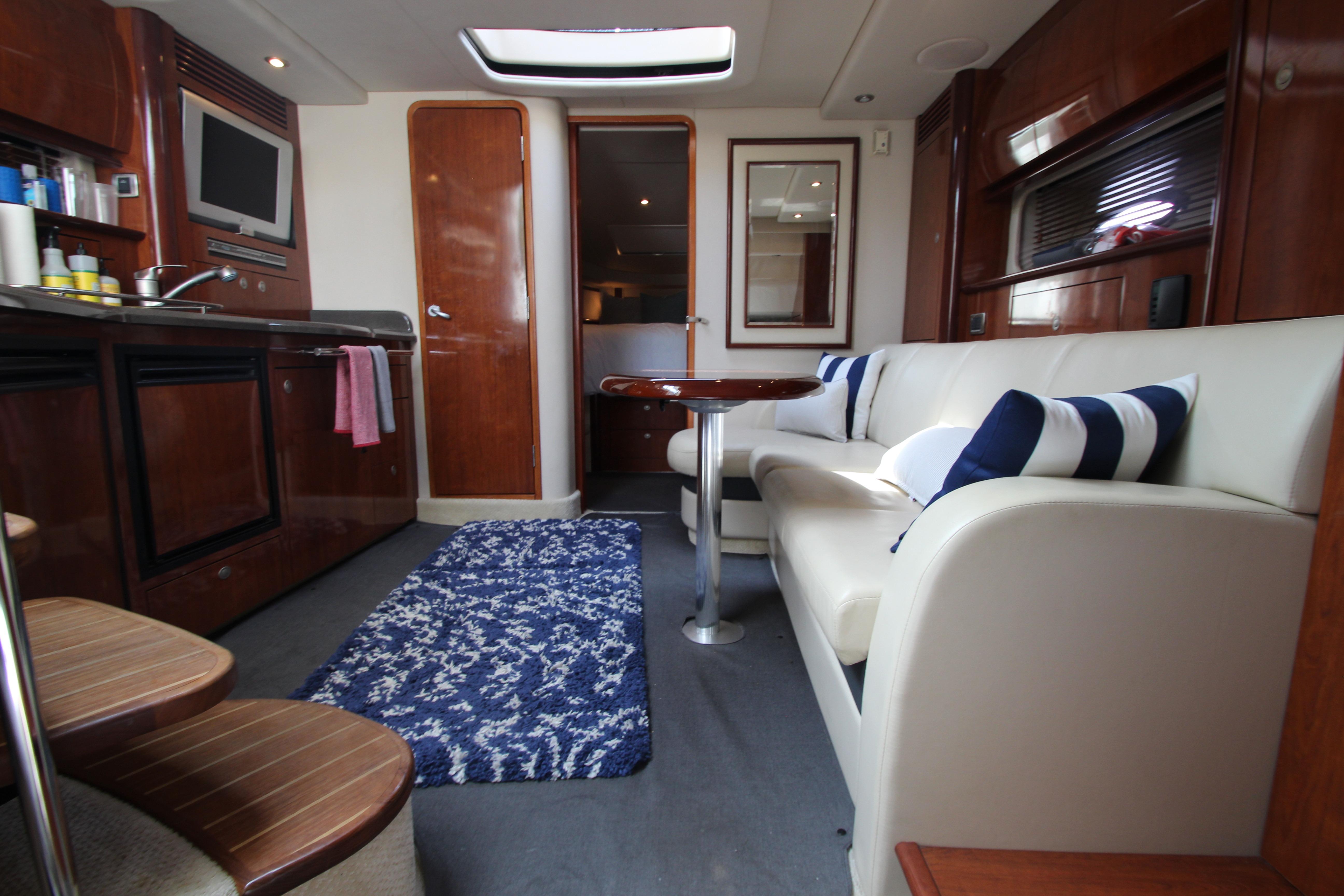 Interior of 2004 Sea Ray 40 Sundancer yacht with modern furnishings and cozy seating area.