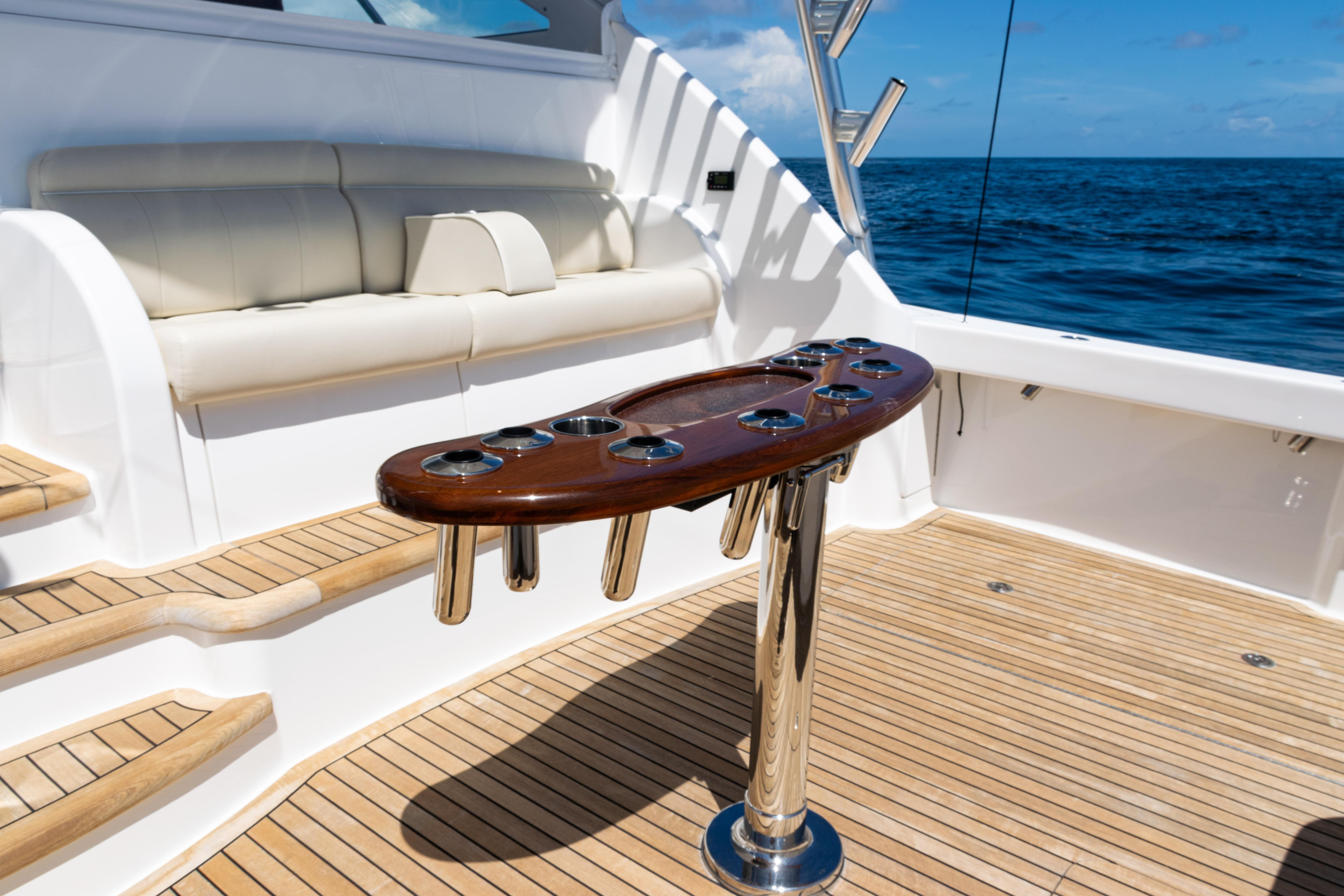 Luxurious 2021 Viking 44 Open yacht deck with seating and rod holders.