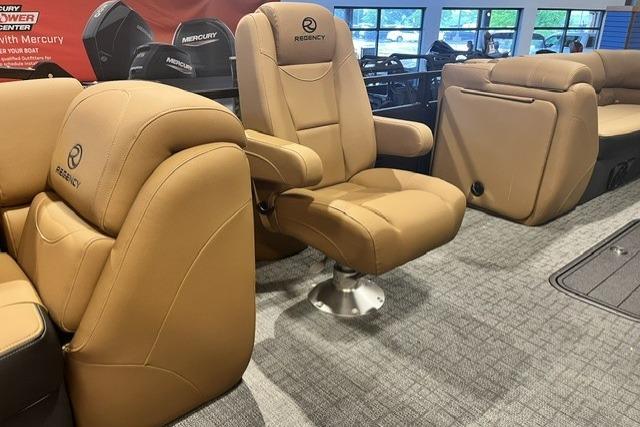 Luxurious seating on 2026 Regency 230 DL boat with tan upholstery and modern design.