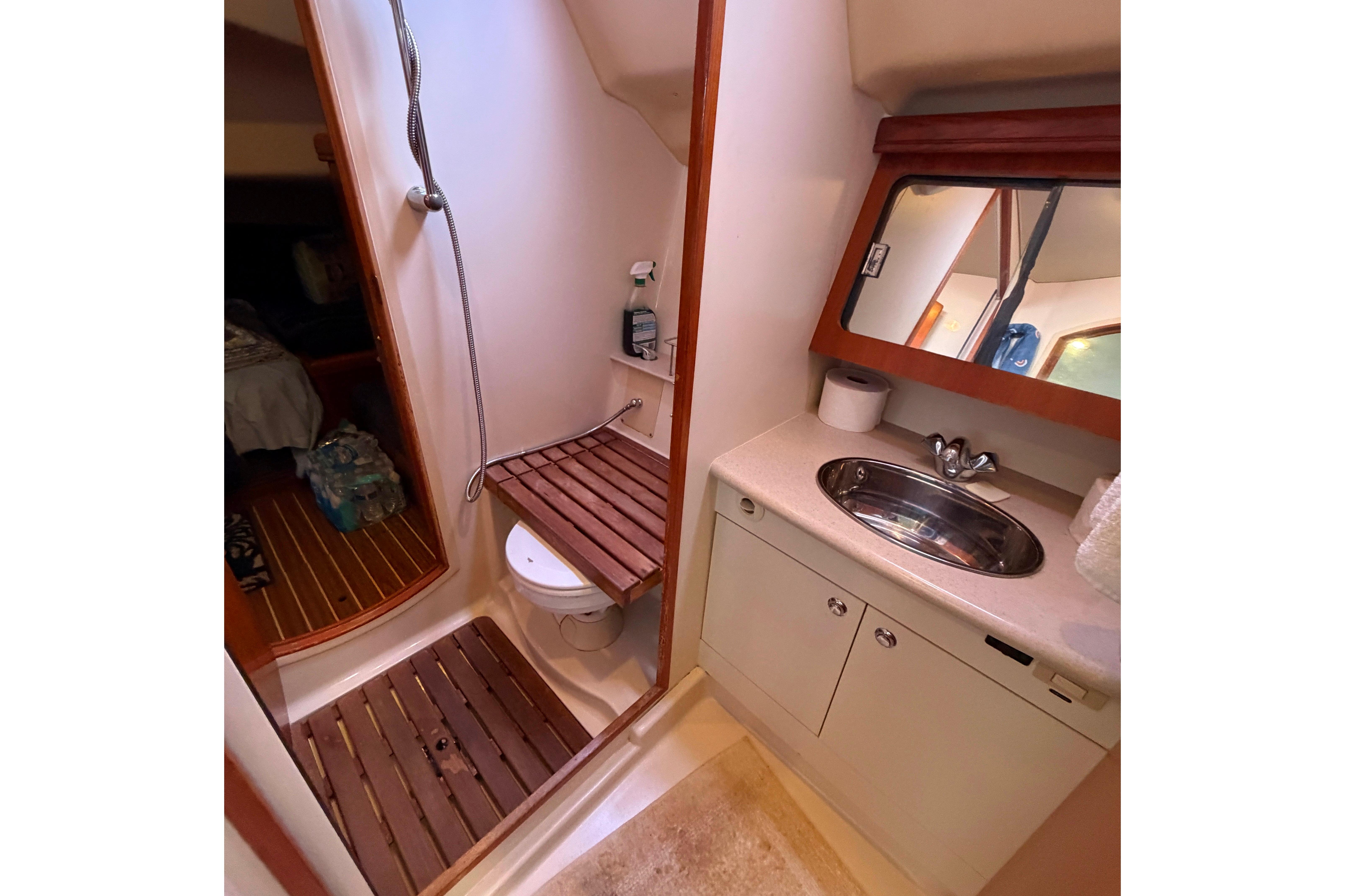 Bathroom interior of 2005 Hunter 38 yacht with shower, toilet, and sink.