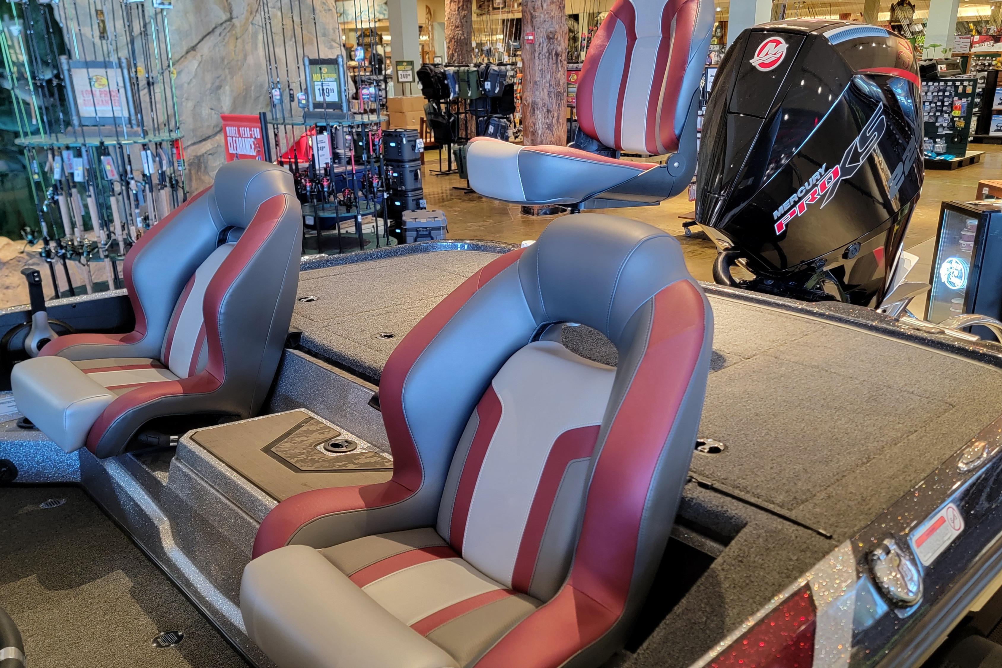 2025 Nitro Z20 XL Pro boat interior with red and gray seats, displayed in a showroom.