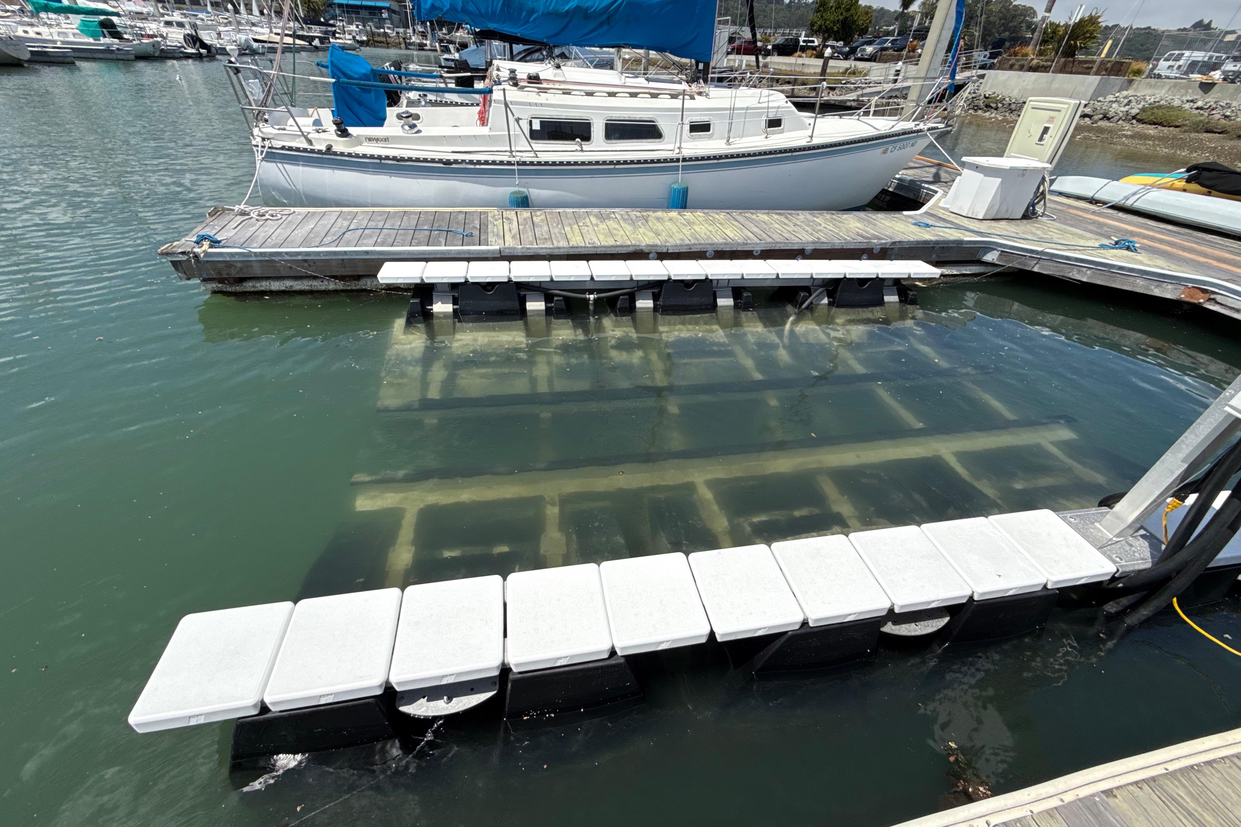 Floating dock with submerged Bayliner VR5 Bowrider I/O, 2021 model, at marina.