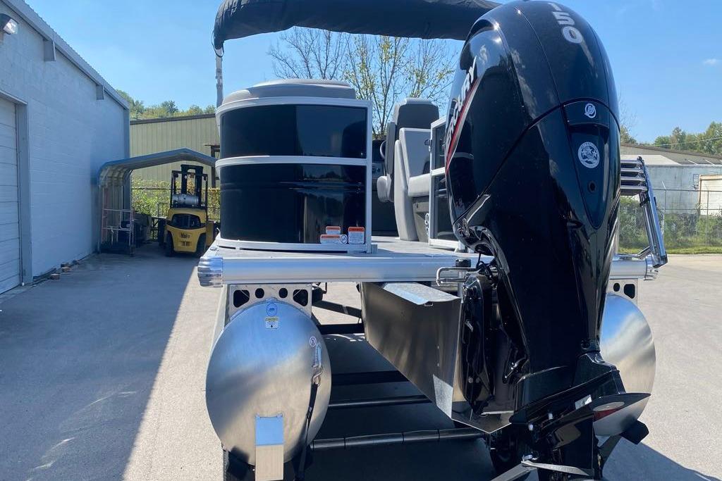 2026 Sun Tracker Party Barge 22 DLX pontoon boat with powerful outboard motor.