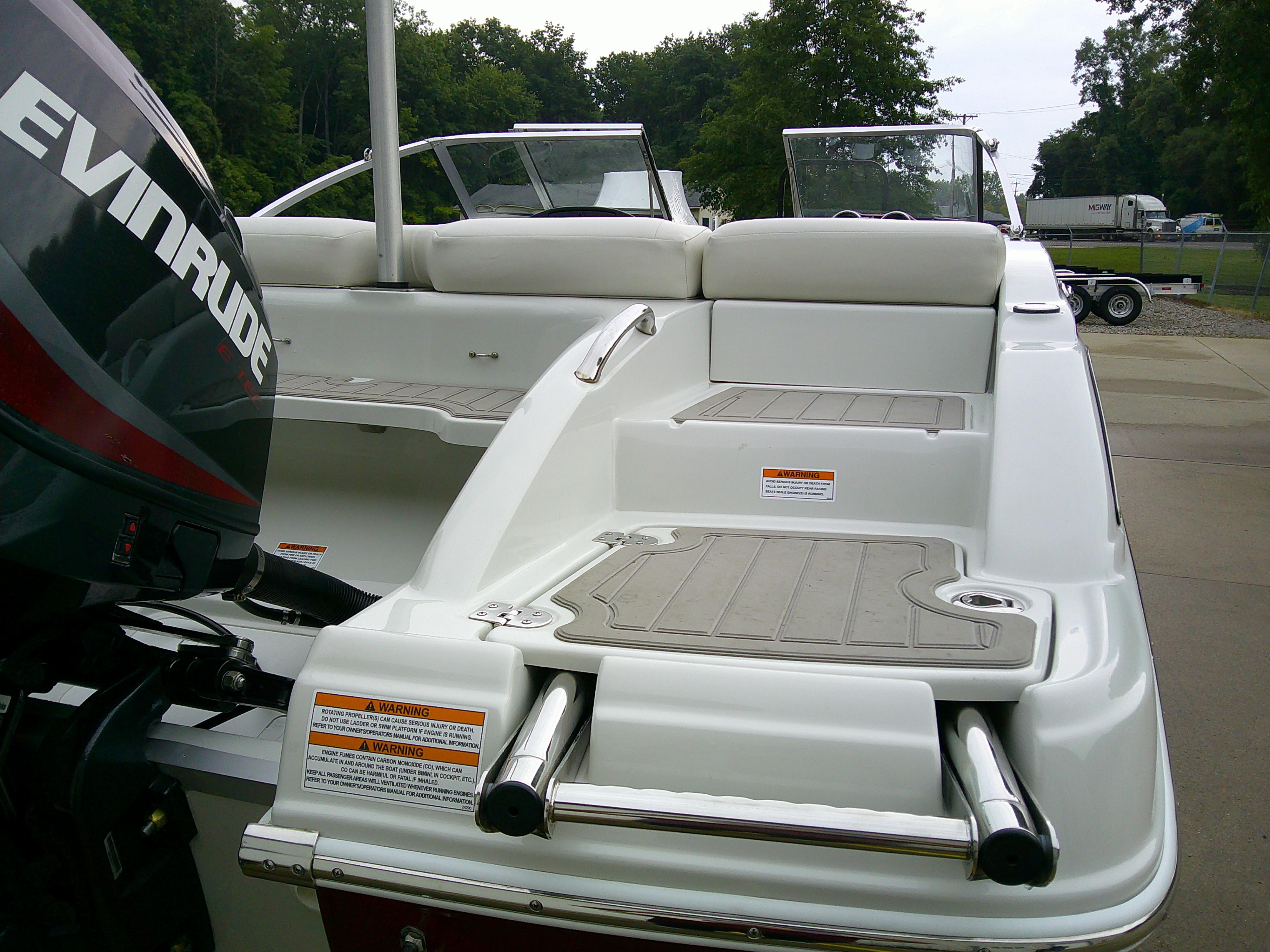 2019 Crownline 19 XS boat with Evinrude motor, featuring spacious seating and swim platform.