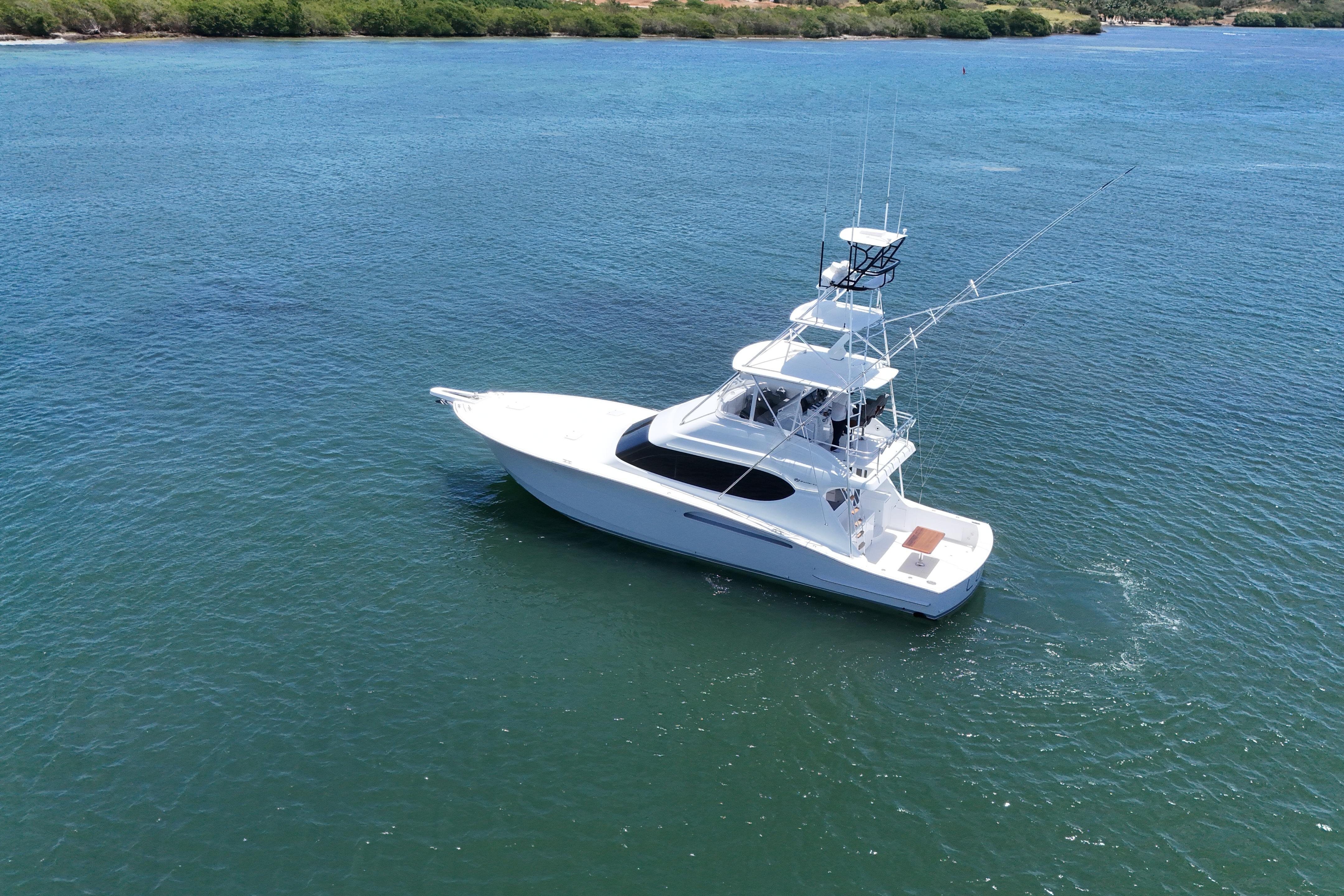 2003 Hatteras 54 Convertible yacht cruising on serene blue waters.