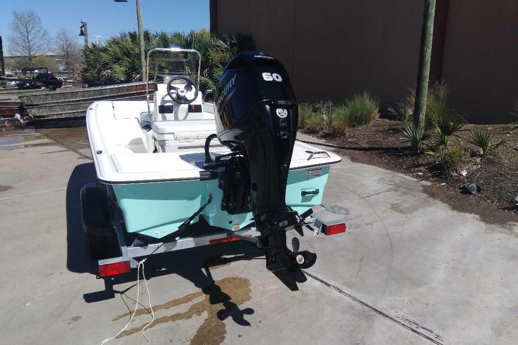 2026 Mako Pro Skiff 15 CC boat on trailer with outboard motor in sunny setting.