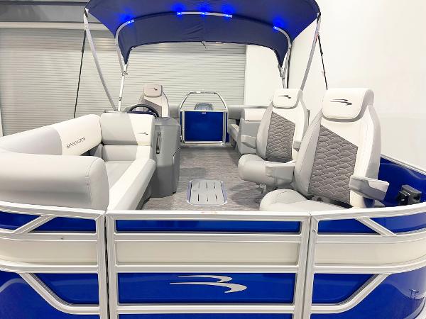 2025 Bennington 20S pontoon boat with blue and white interior, canopy, and comfortable seating.