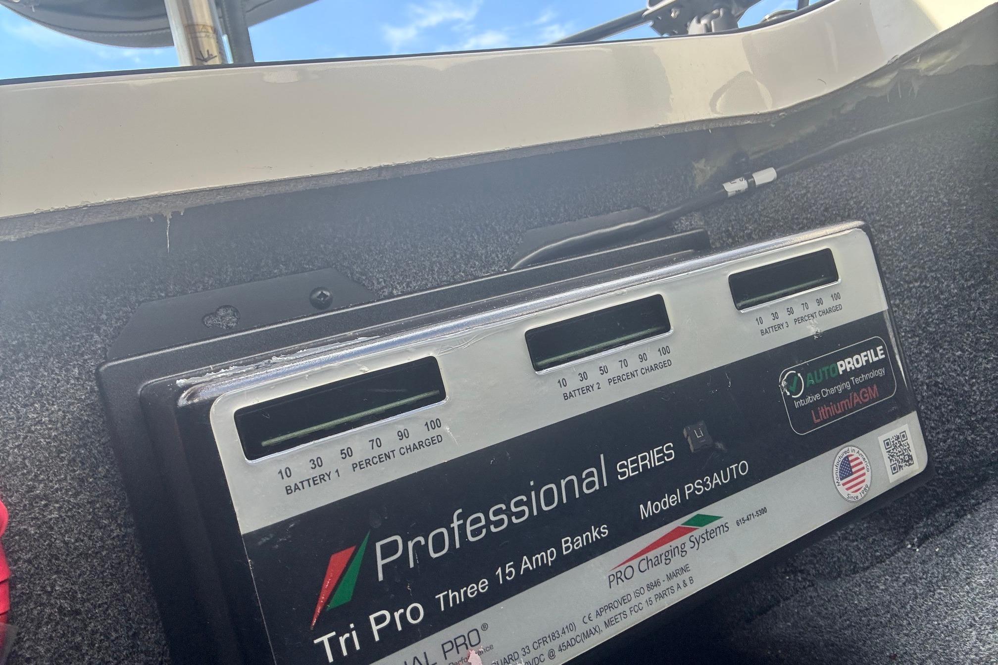 Professional Series battery charger in a 2022 Ranger 1880MS boat, under a clear blue sky.