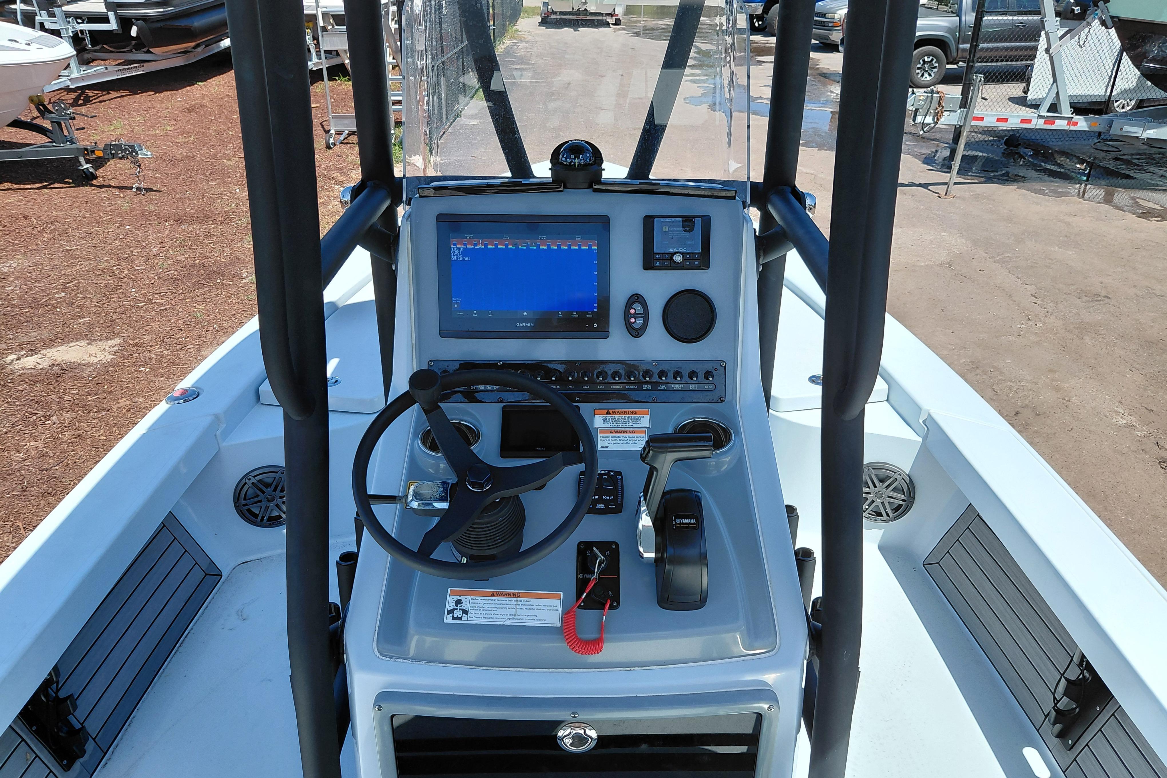 2022 Pathfinder 2300 HPS boat console with steering wheel and navigation display.
