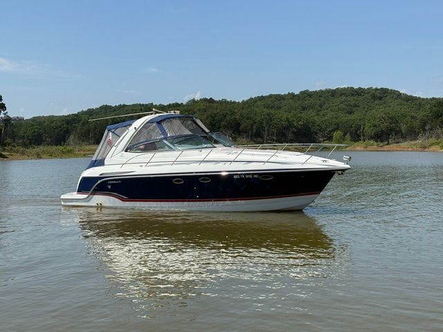 2007 Formula 34 Performance Cruiser on calm water with wooded shoreline in the background.