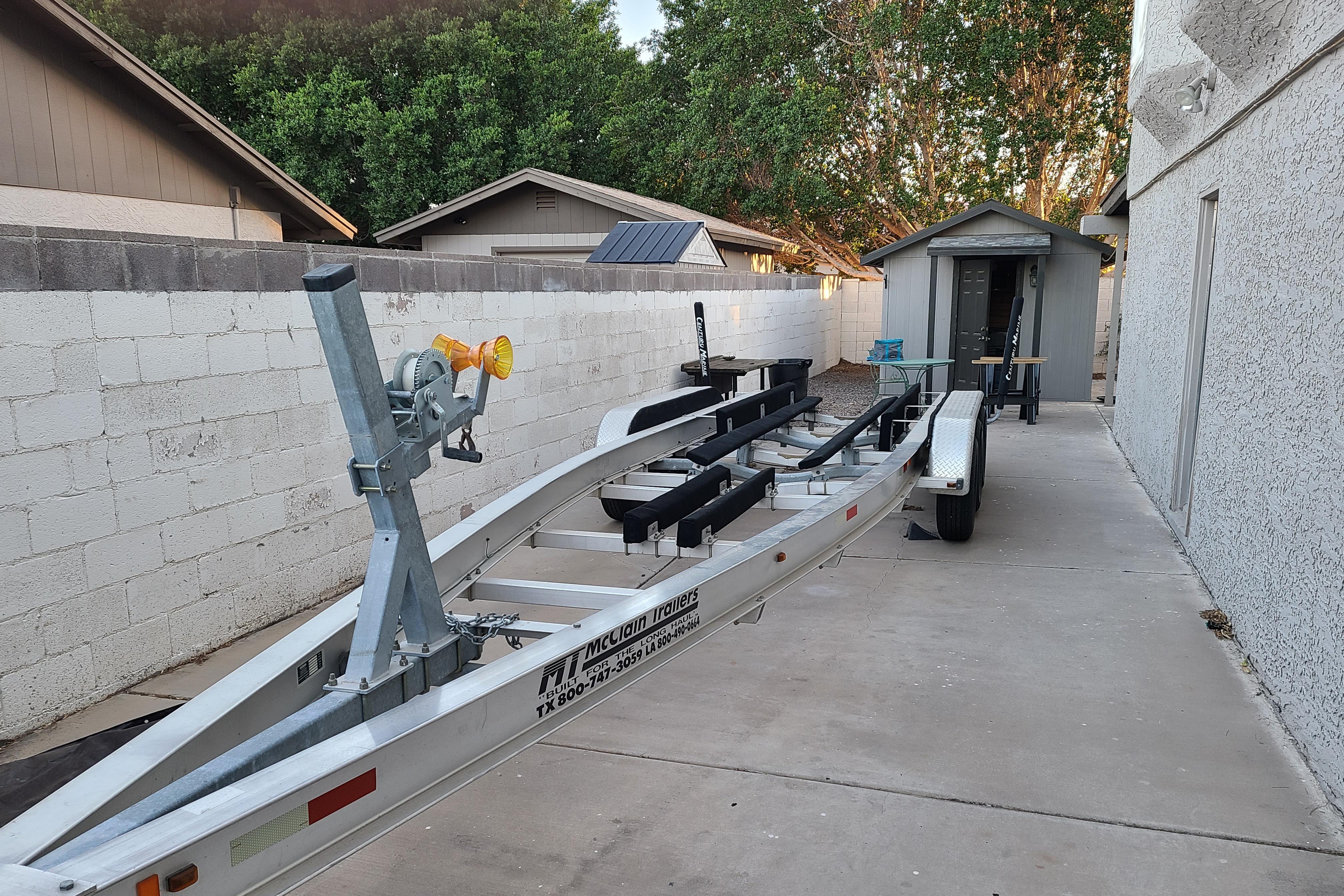 Boat trailer parked in driveway, suitable for 1999 Chaparral Signature 300.
