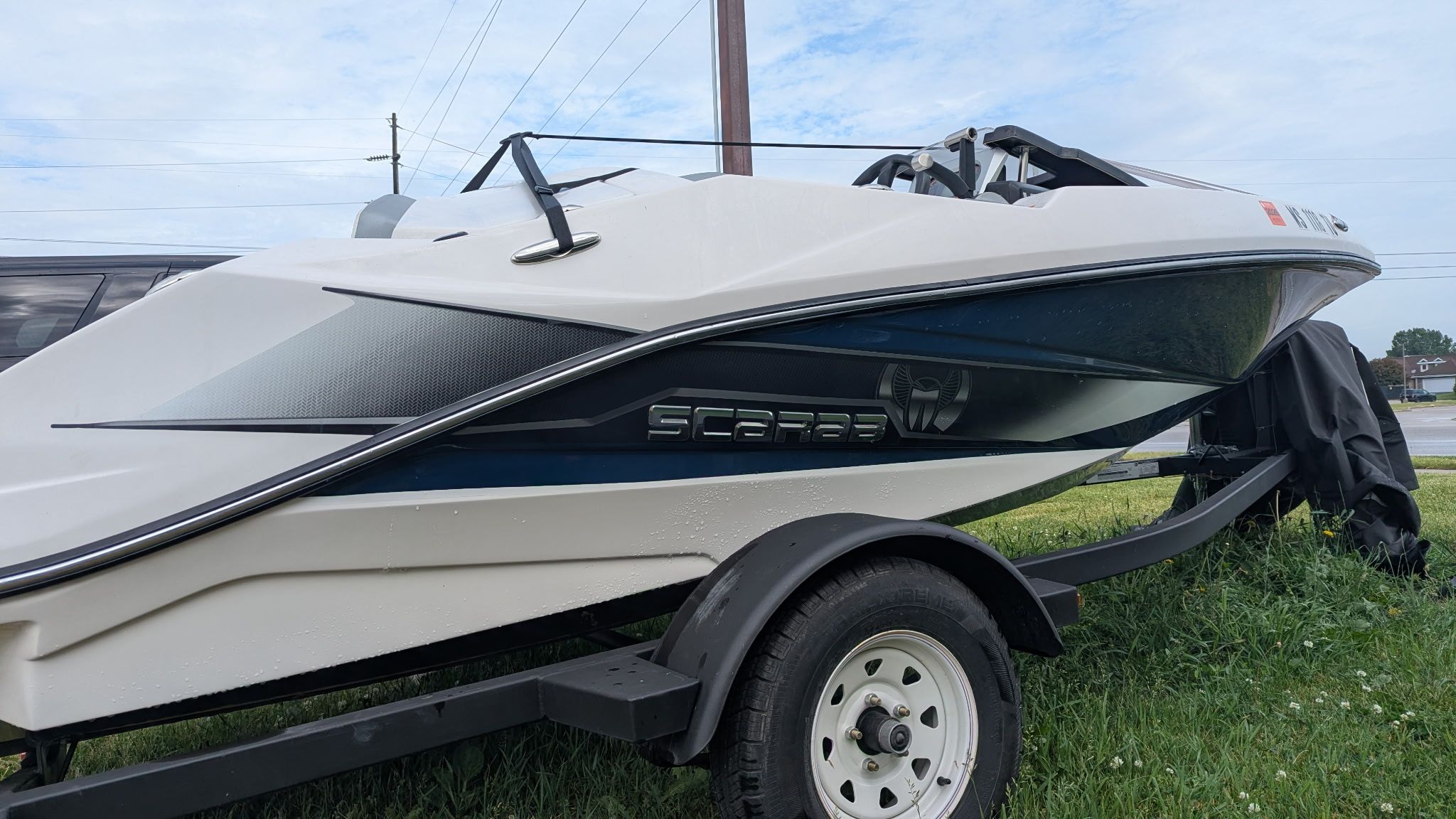 2017 Scarab 165 H.O. boat on trailer outdoors.