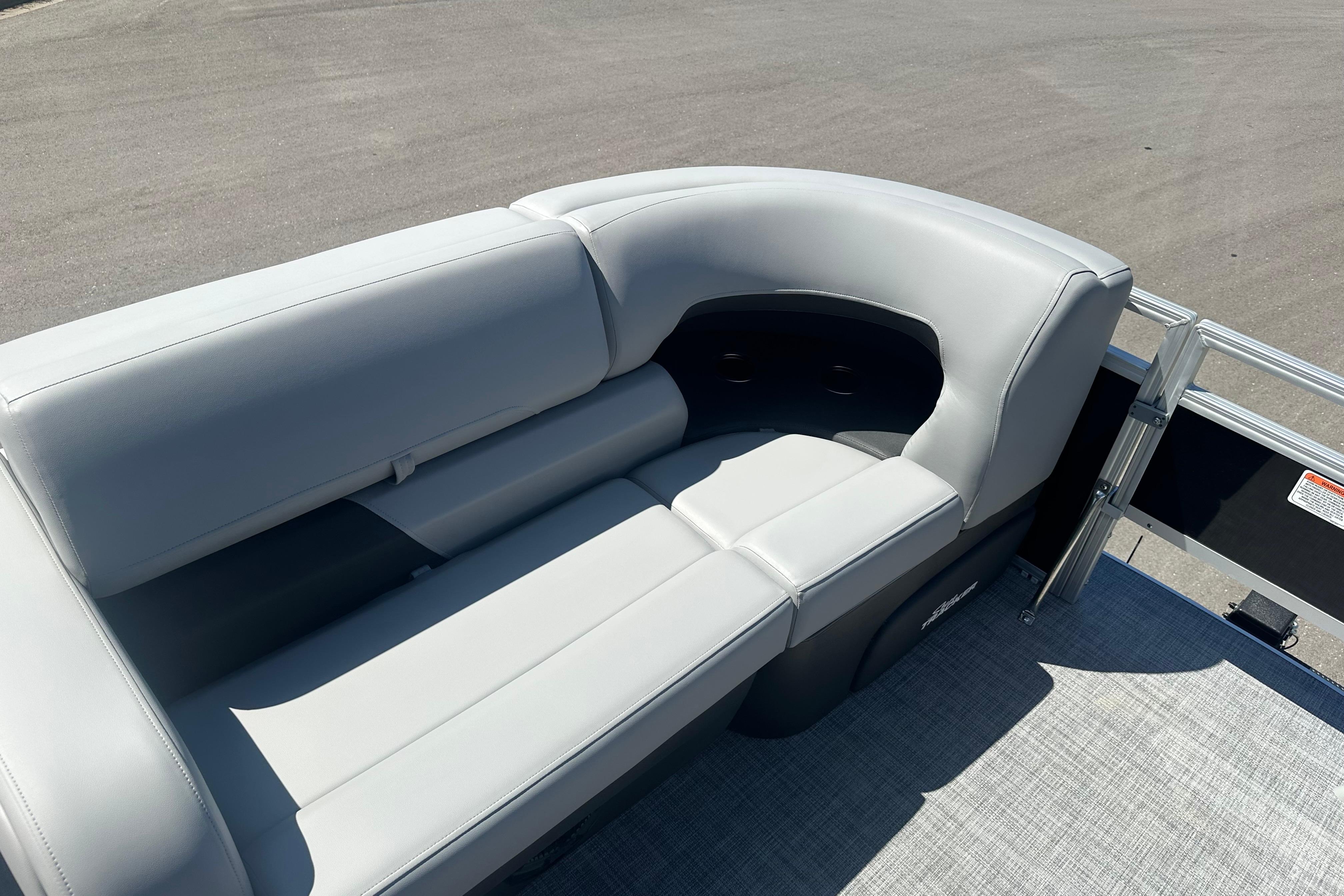 2026 Sun Tracker SportFish 22 DLX pontoon boat with sleek gray seating.