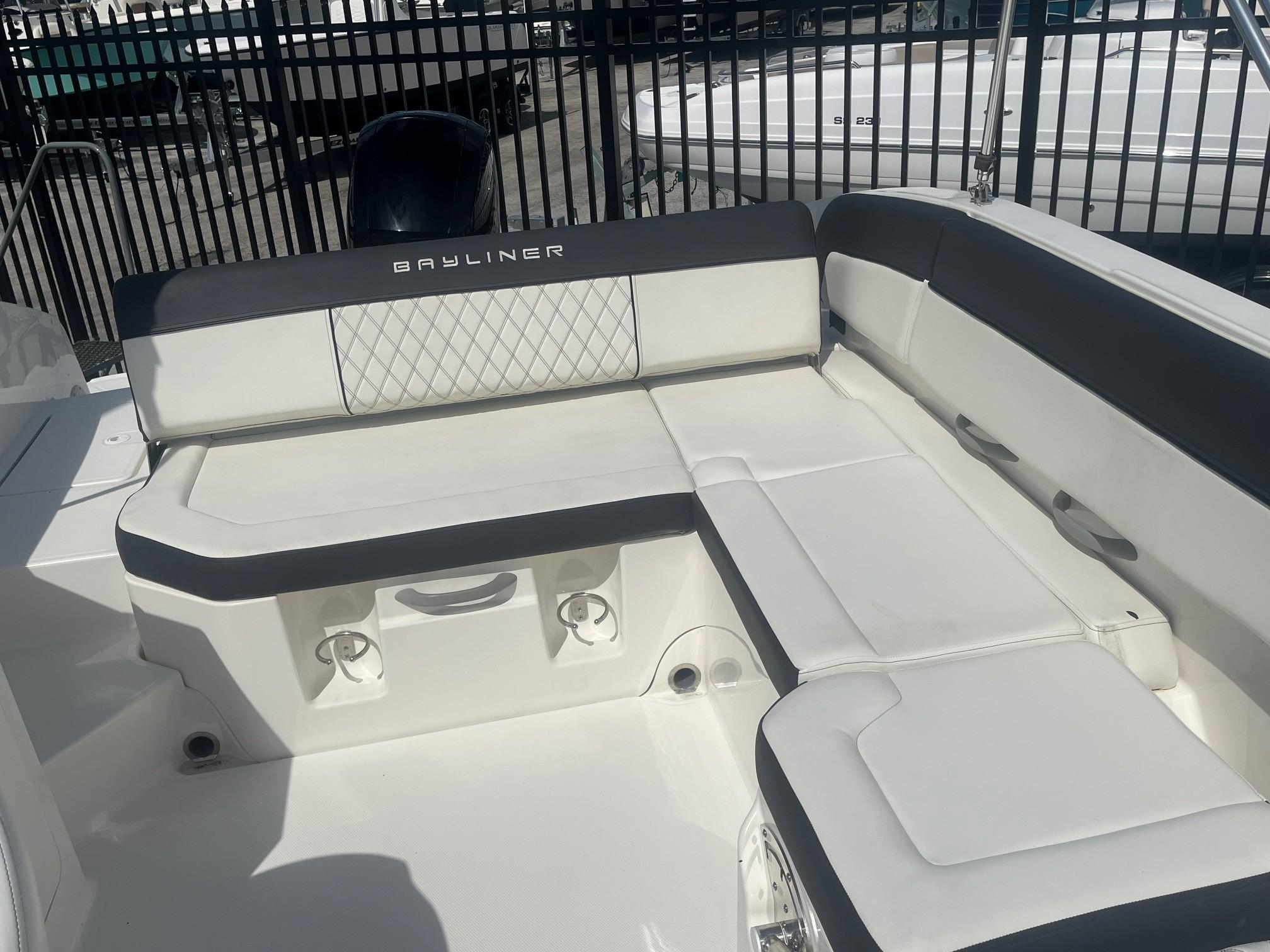 2022 Bayliner DX 2200 boat interior with white seating and black accents.