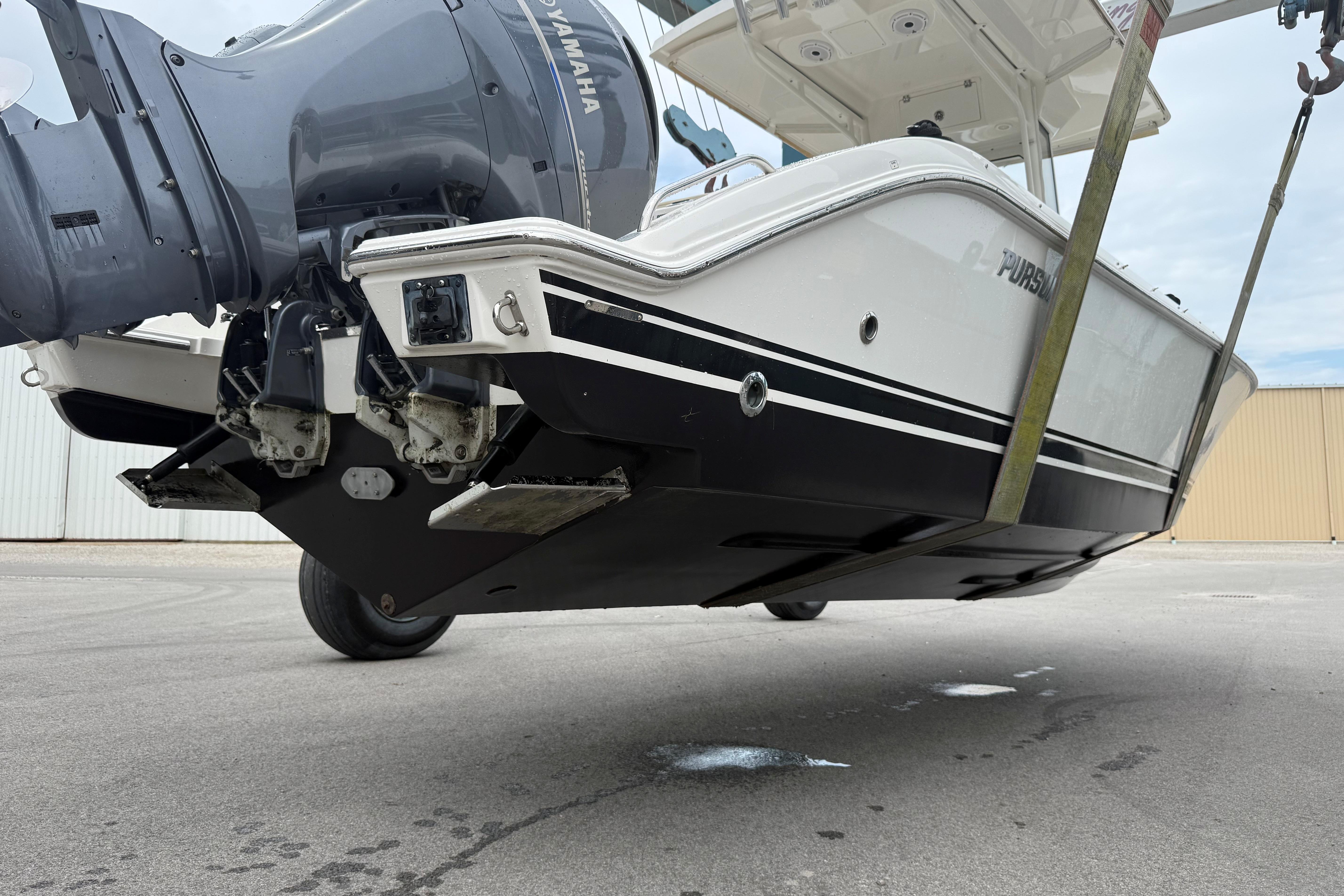 2021 Pursuit S 268 Sport boat with Yamaha engine, lifted for maintenance.