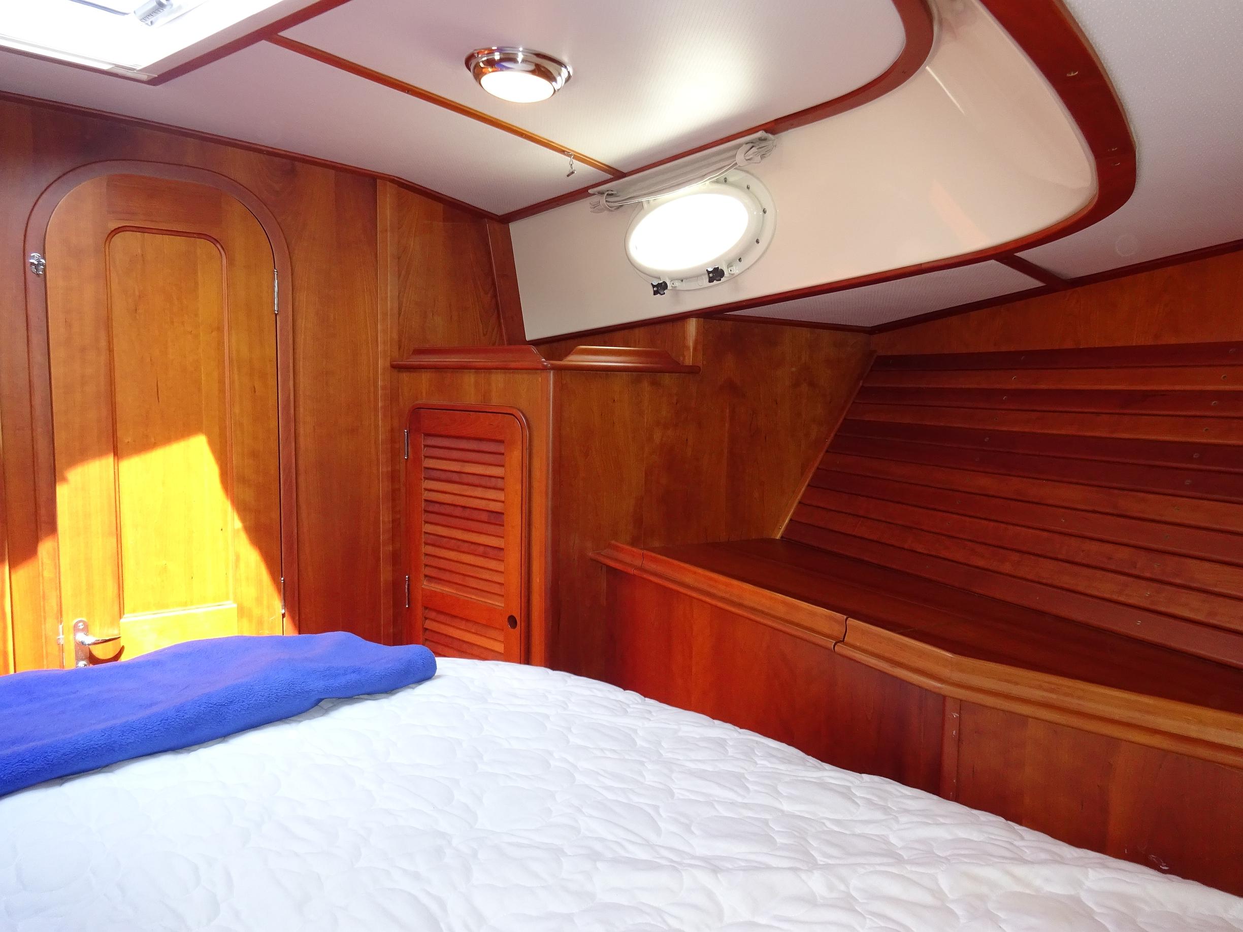 Interior cabin of 2002 Hinckley Talaria 44 FB yacht with wooden finish.