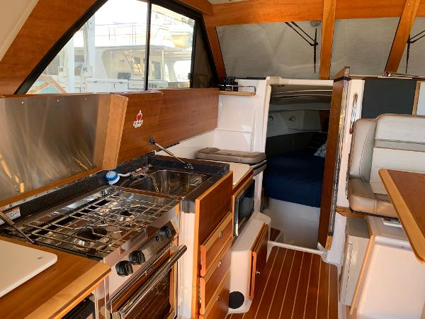 2021 Cutwater C-32 CB interior with kitchen, seating, and sleeping area.