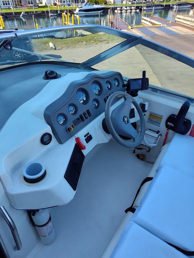1994 Sea Ray 230 Sundancer cockpit with steering wheel and gauges.