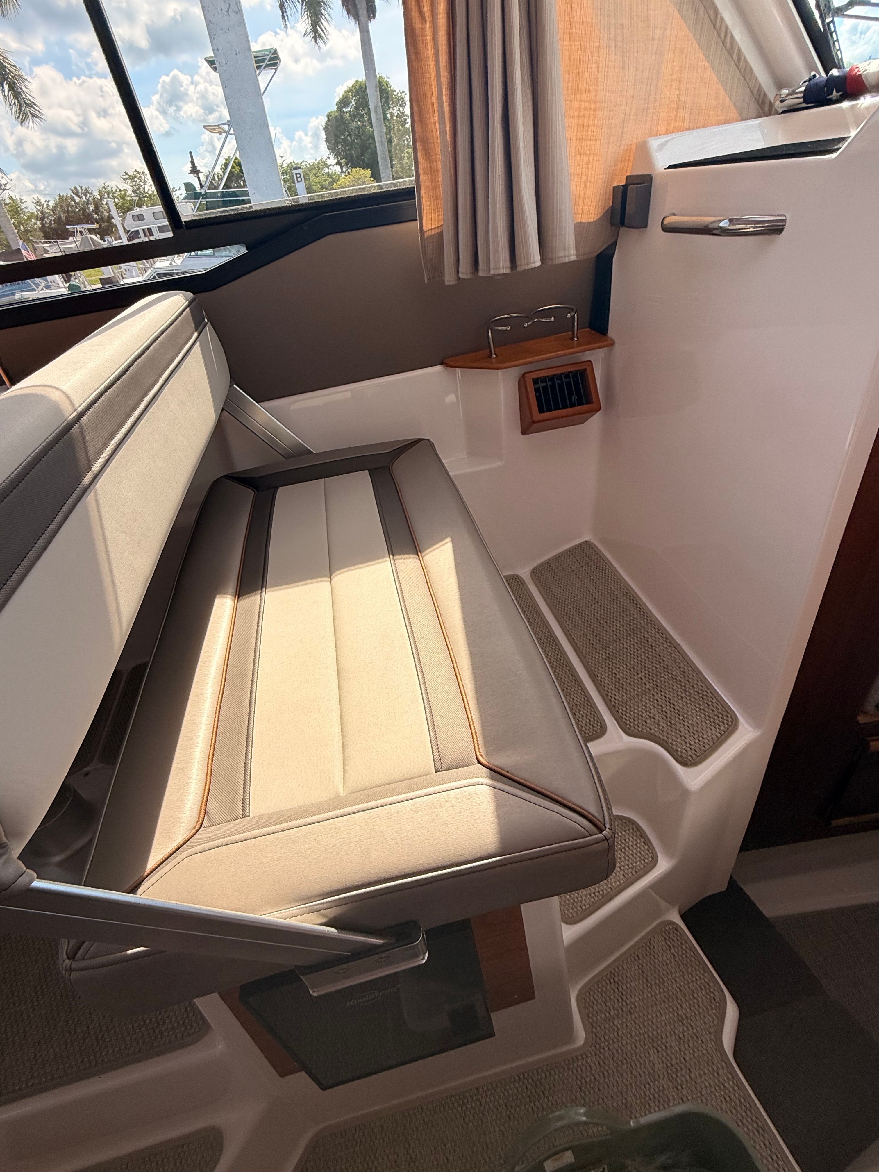 Interior of the 2023 Cutwater C-228 with cushioned seating and windows.