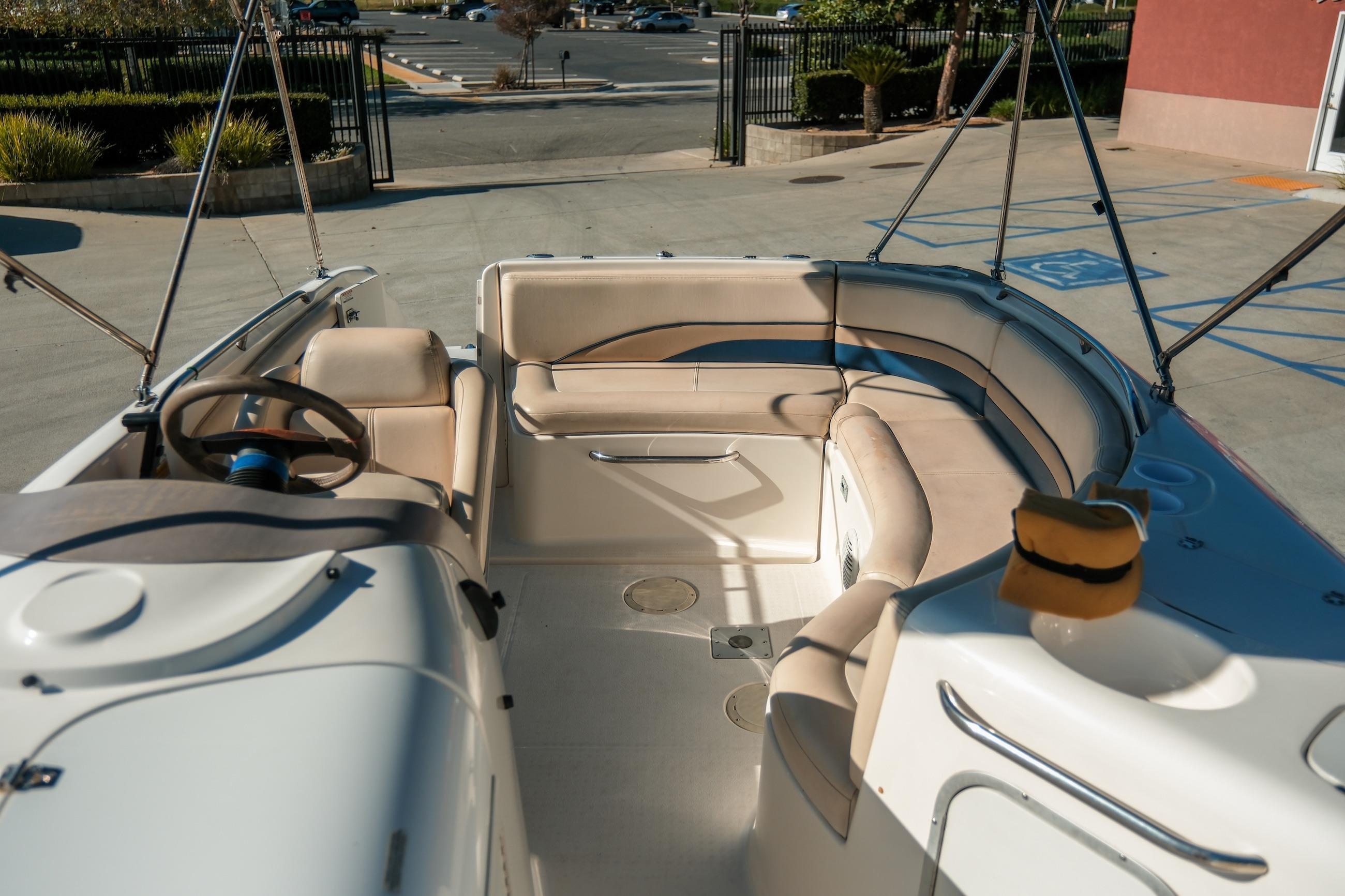 1998 Chaparral 232 Sunesta boat interior with beige seating and steering wheel.