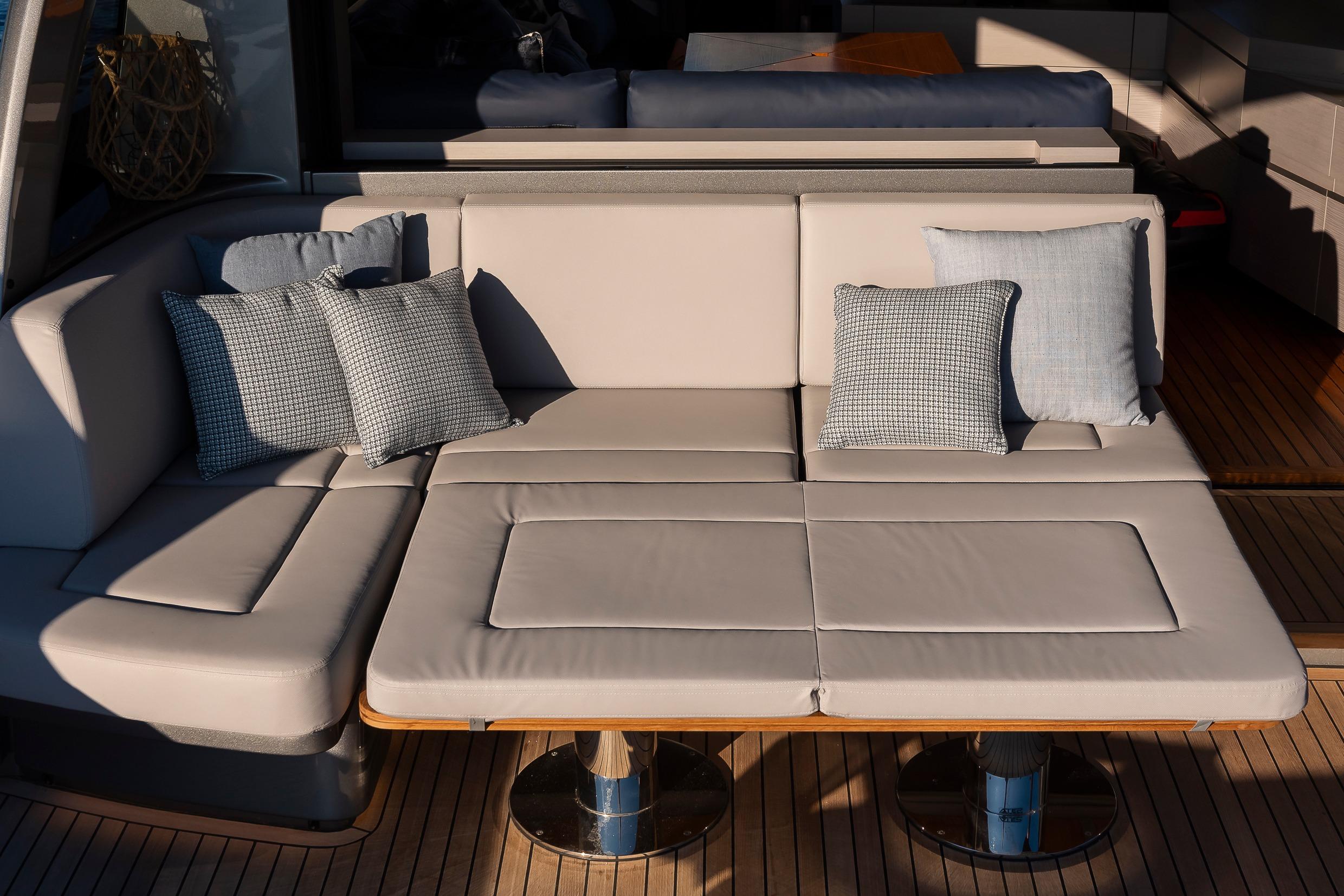 Luxurious seating area on 2021 Pershing 7X yacht with plush cushions and sleek design.