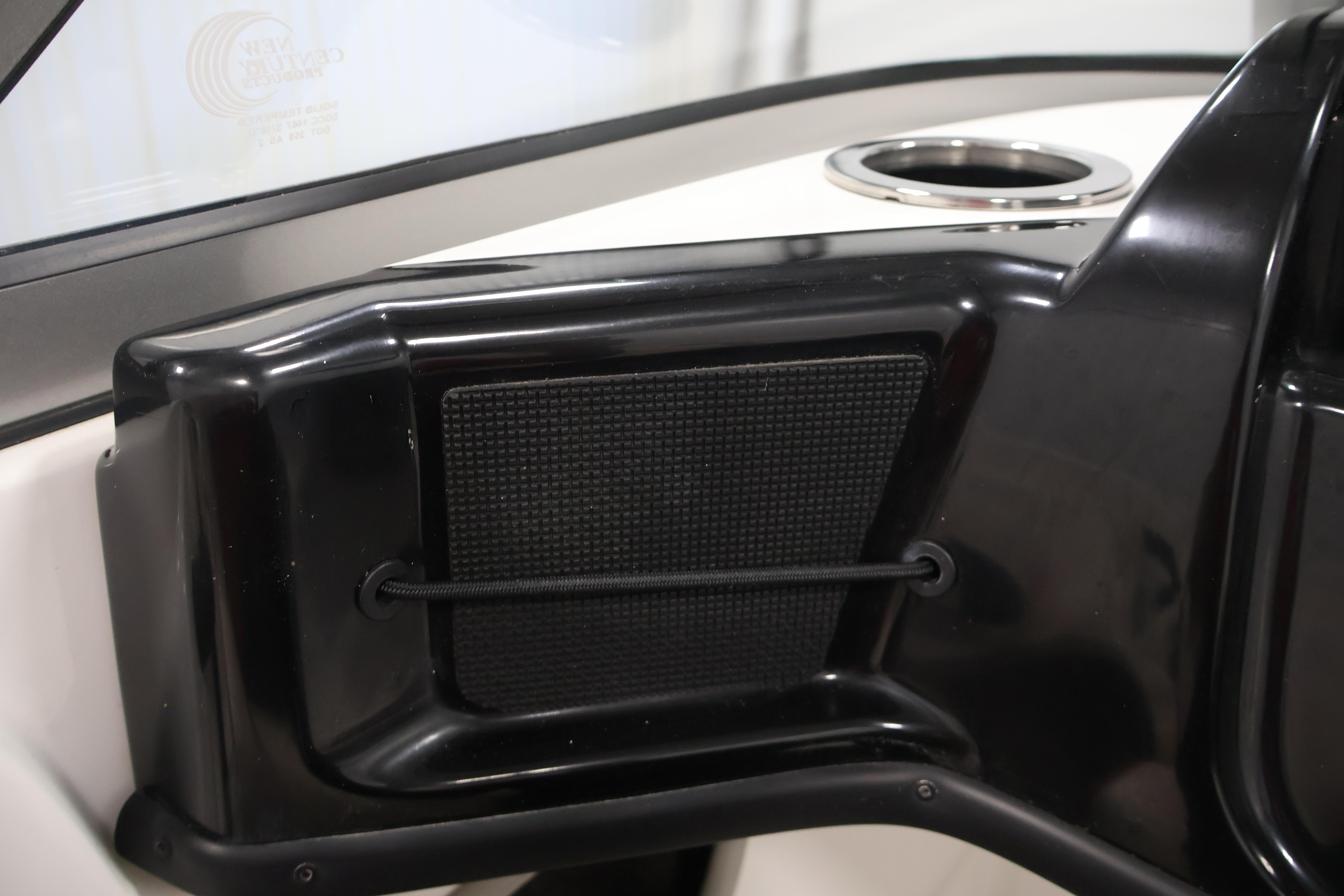 Interior detail of a 2019 Nitro Z19 Sport boat, featuring a black panel and cup holder.