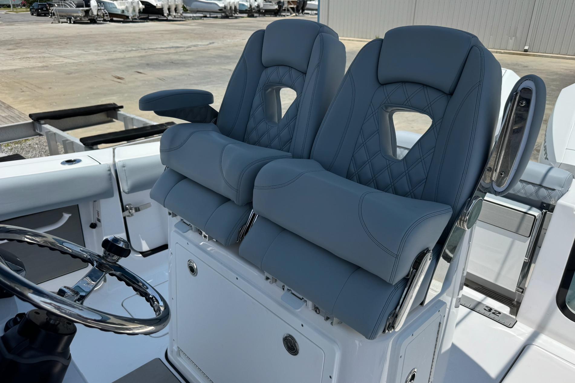 2026 Sportsman Open 262 Center Console boat with dual cushioned seats and steering wheel.