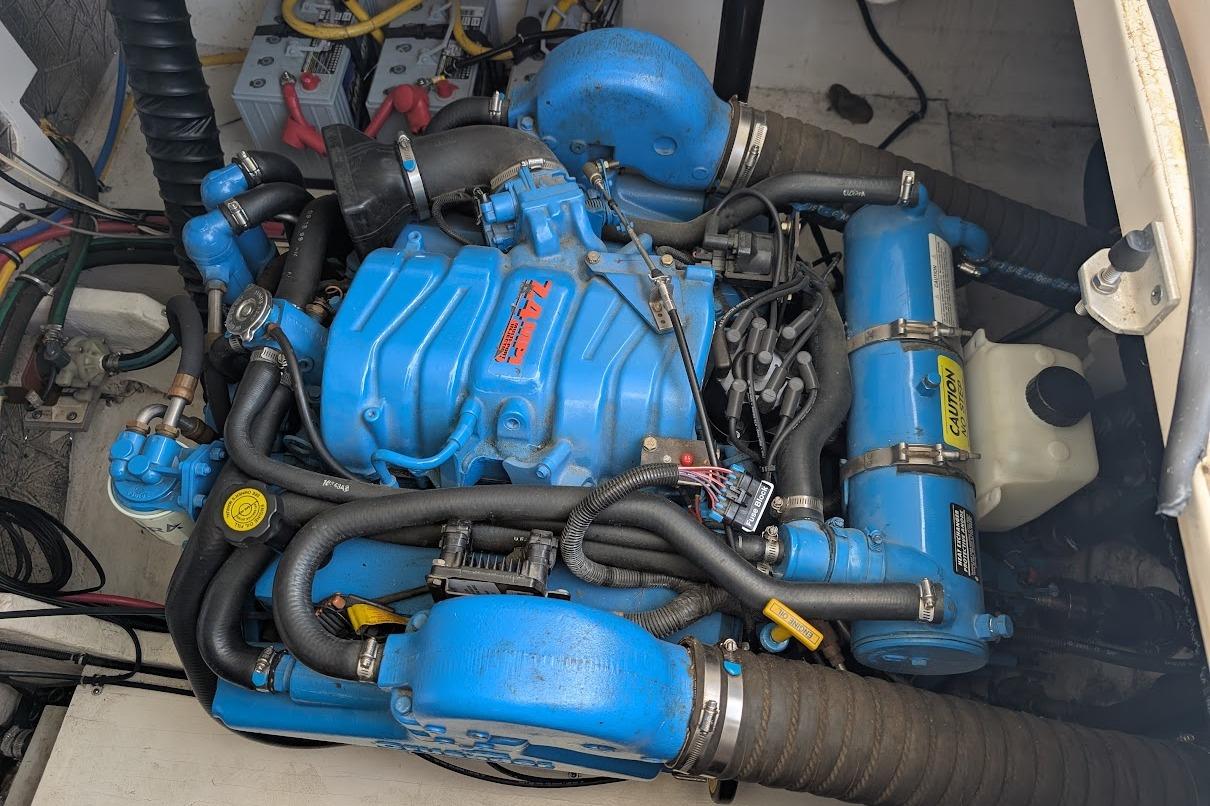 Engine compartment of a 2000 Pursuit 3400 Express boat, featuring a blue marine engine.