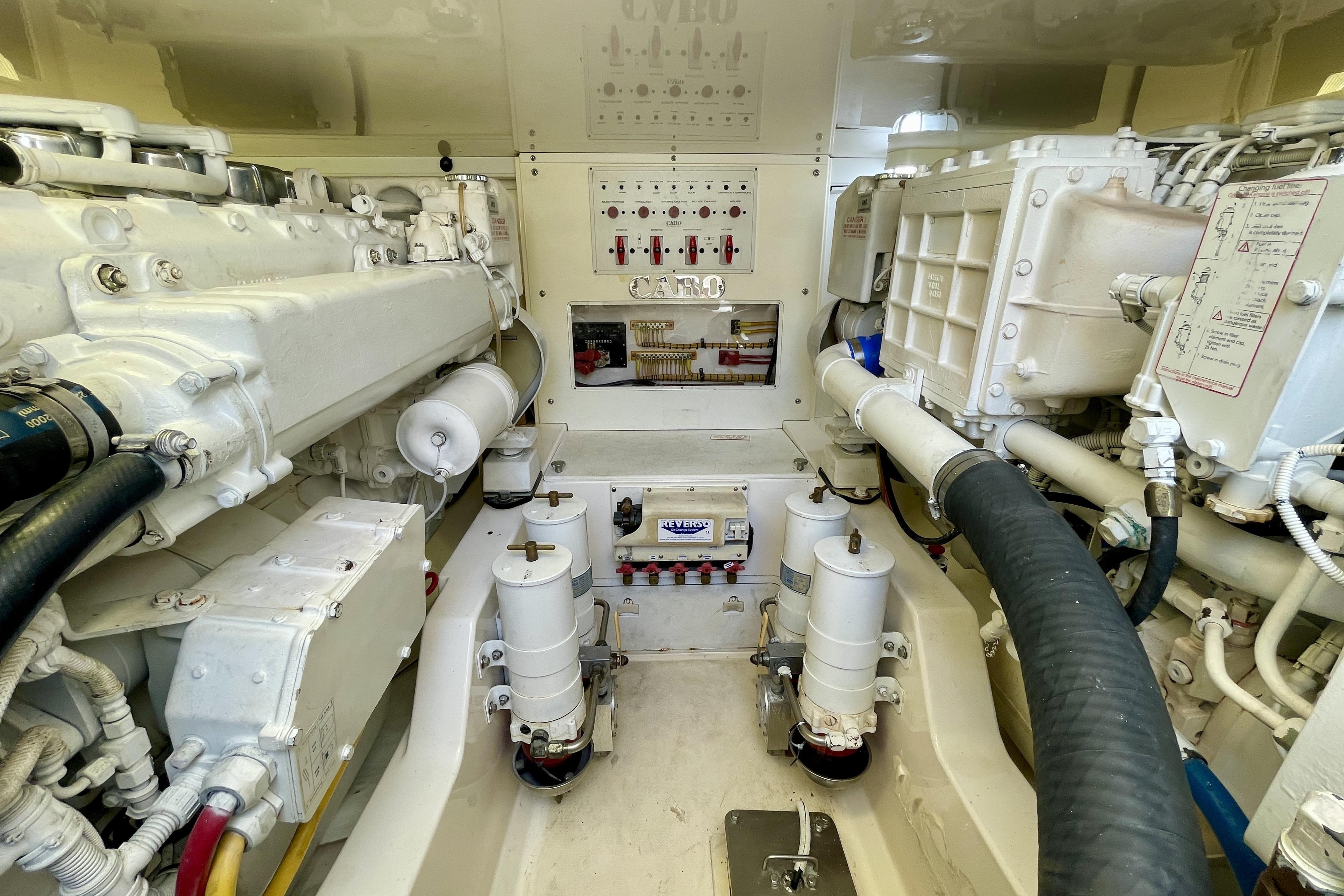 Engine room of a 2006 Cabo 40 Flybridge yacht, showcasing mechanical components and systems.