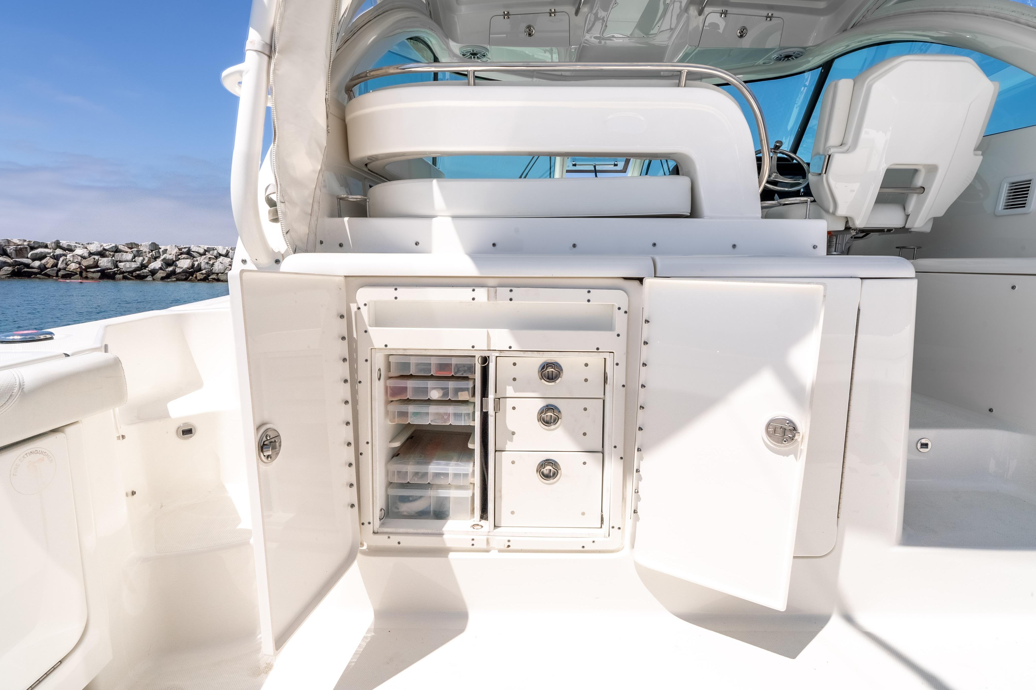 2022 Pursuit OS 385 Offshore boat interior with storage compartments open.