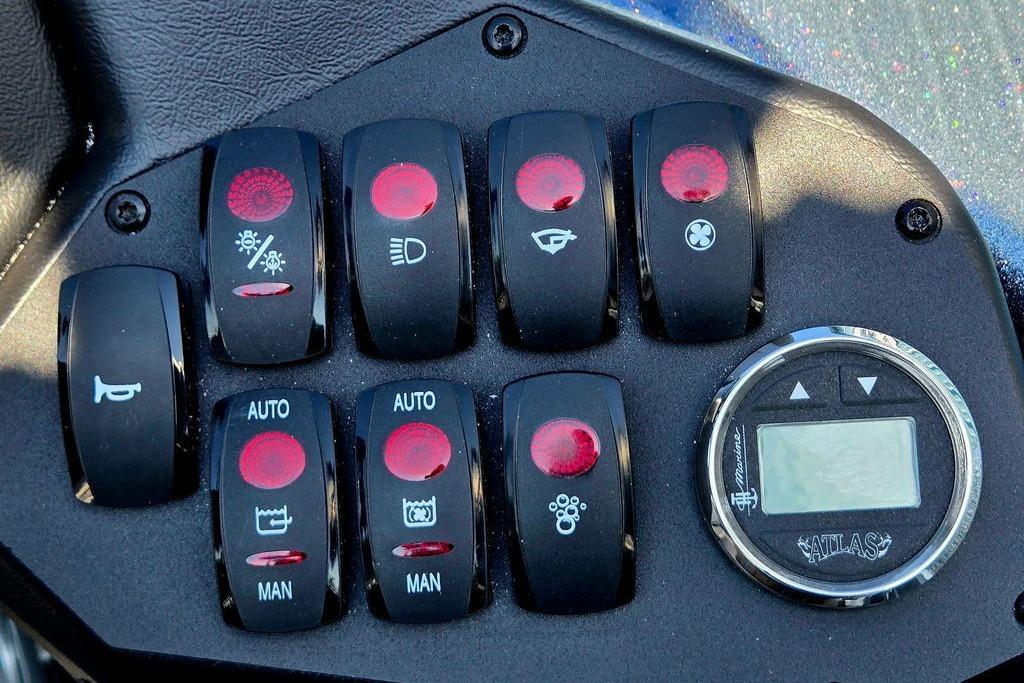 Control panel of a 2026 Skeeter ZXE20 boat with various switches and digital display.