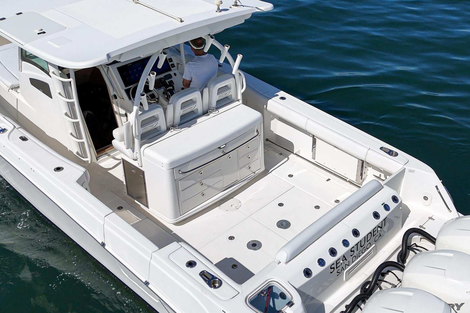 2015 Boston Whaler 370 Outrage boat on water, featuring spacious deck and modern controls.