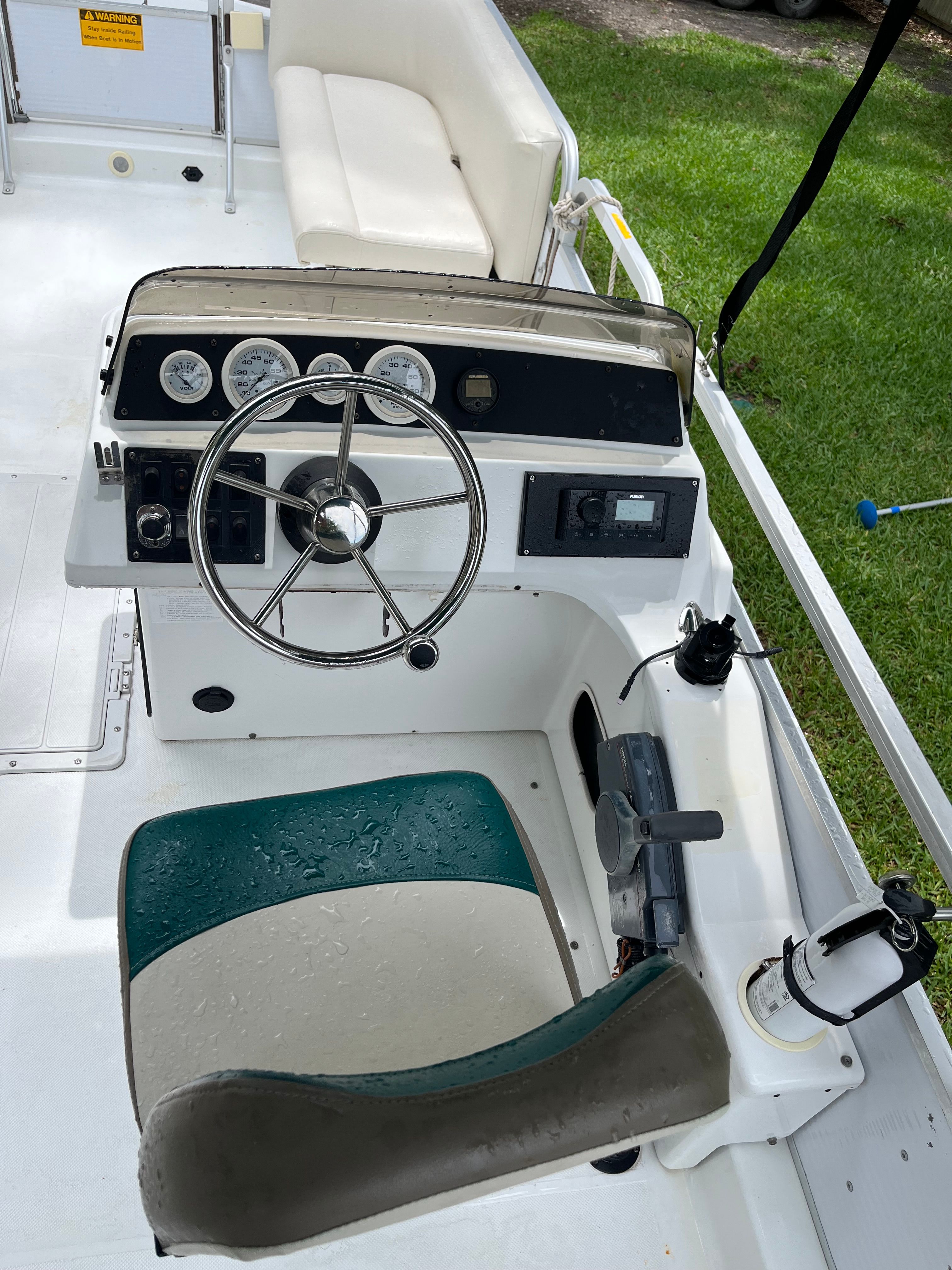 Interior view of a 1993 Hurricane Fun Deck boat with steering console.