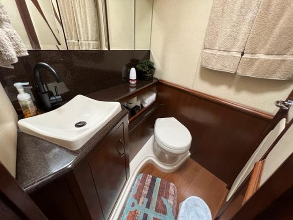 2009 Ovation 52 yacht bathroom with sink, toilet, and storage.