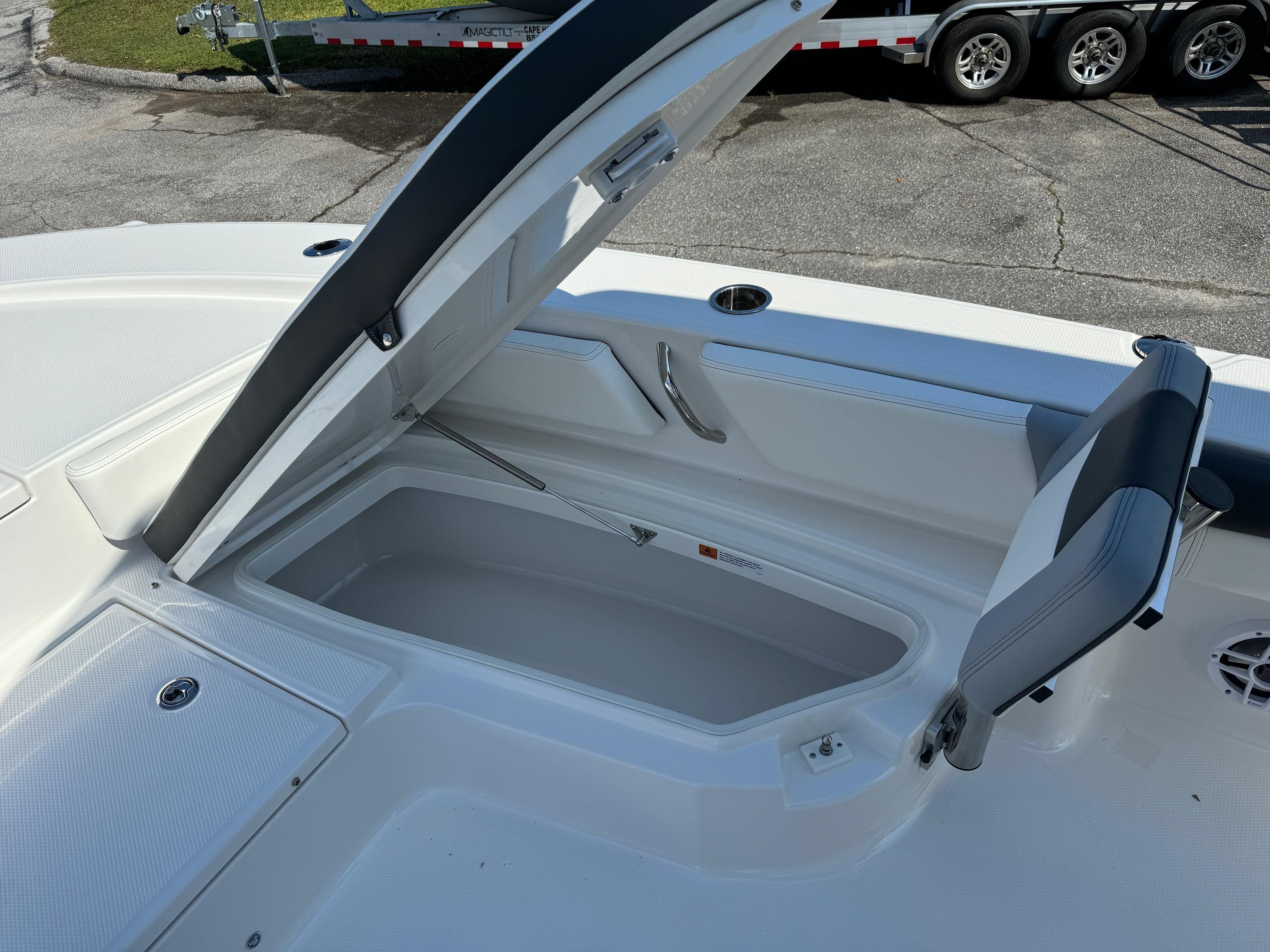 2025 Robalo R246 CAYMAN boat storage compartment open, showcasing spacious interior design.