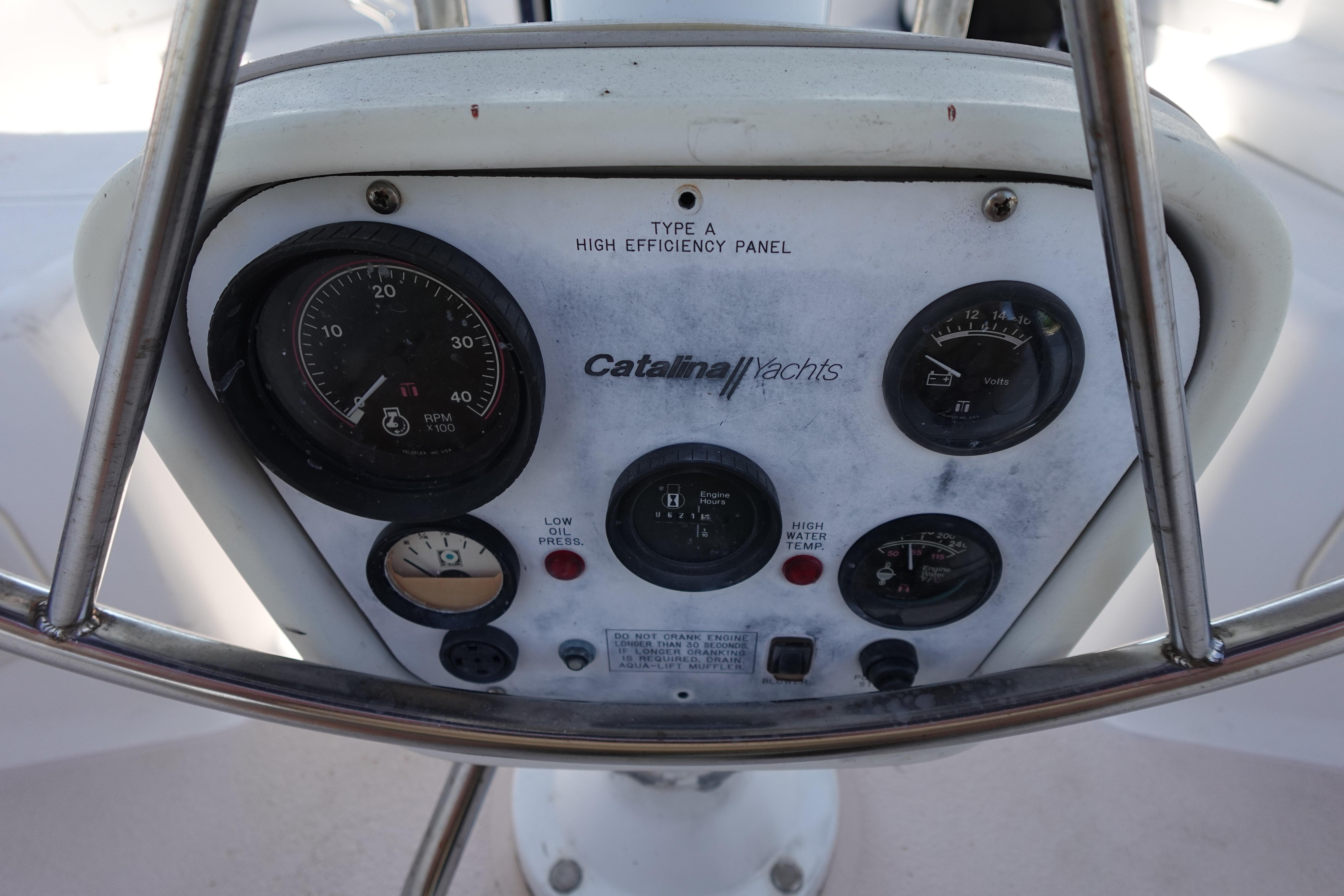 Control panel of a 1997 Catalina 28 yacht with gauges and indicators.