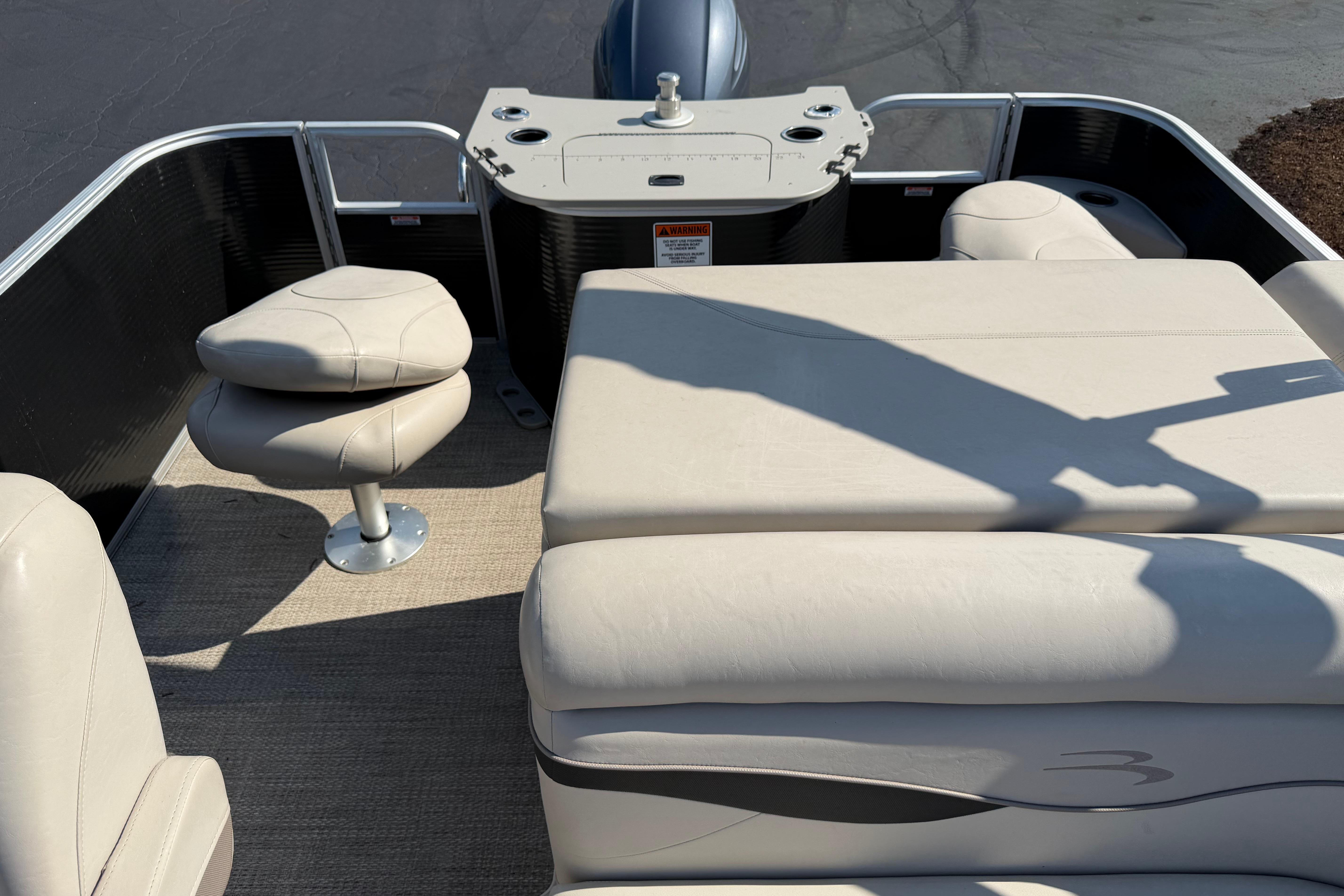 2018 Bennington 21 SF pontoon boat interior with beige seating and helm.