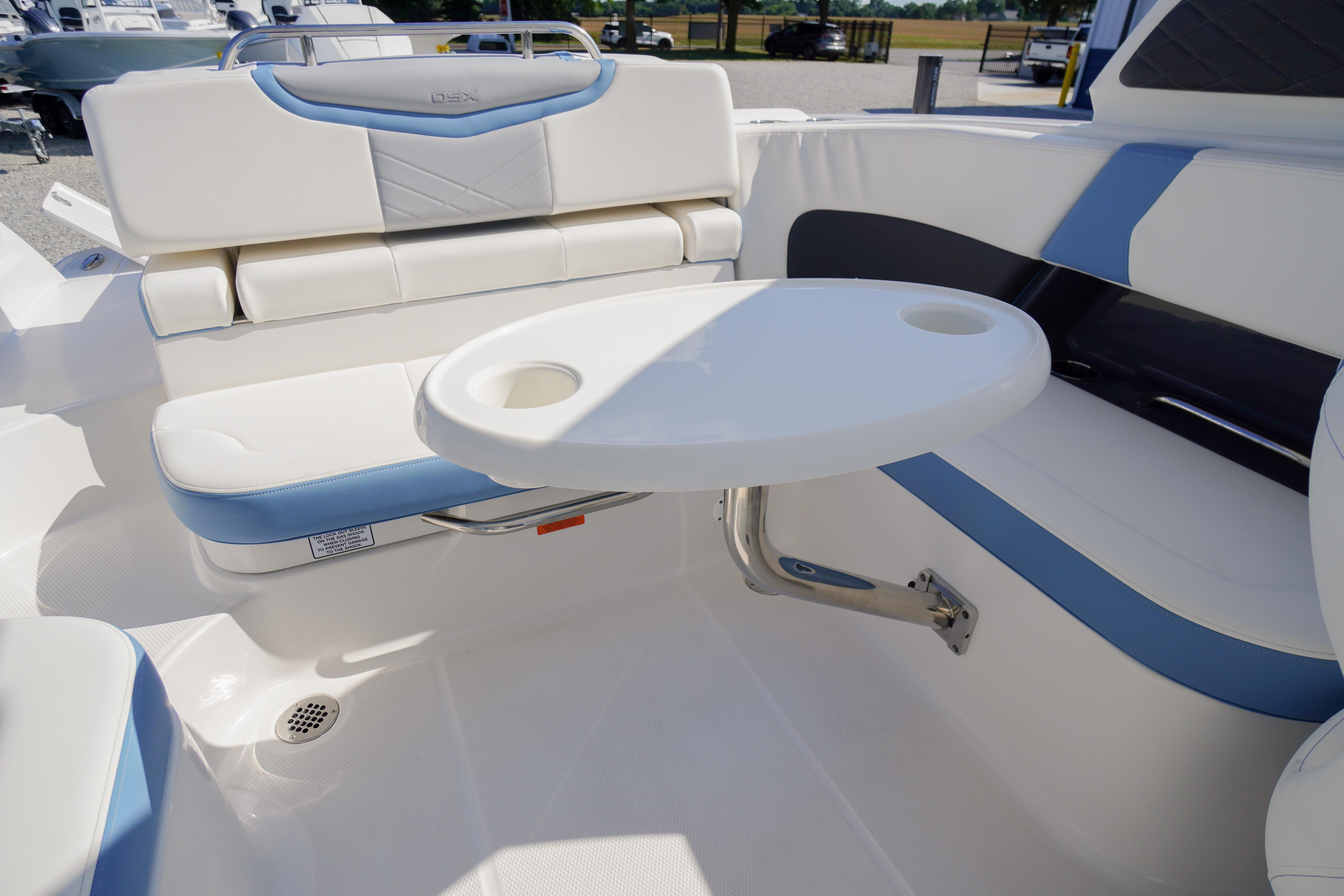 2026 Chaparral 270 OSX boat interior with white seating and a round table.
