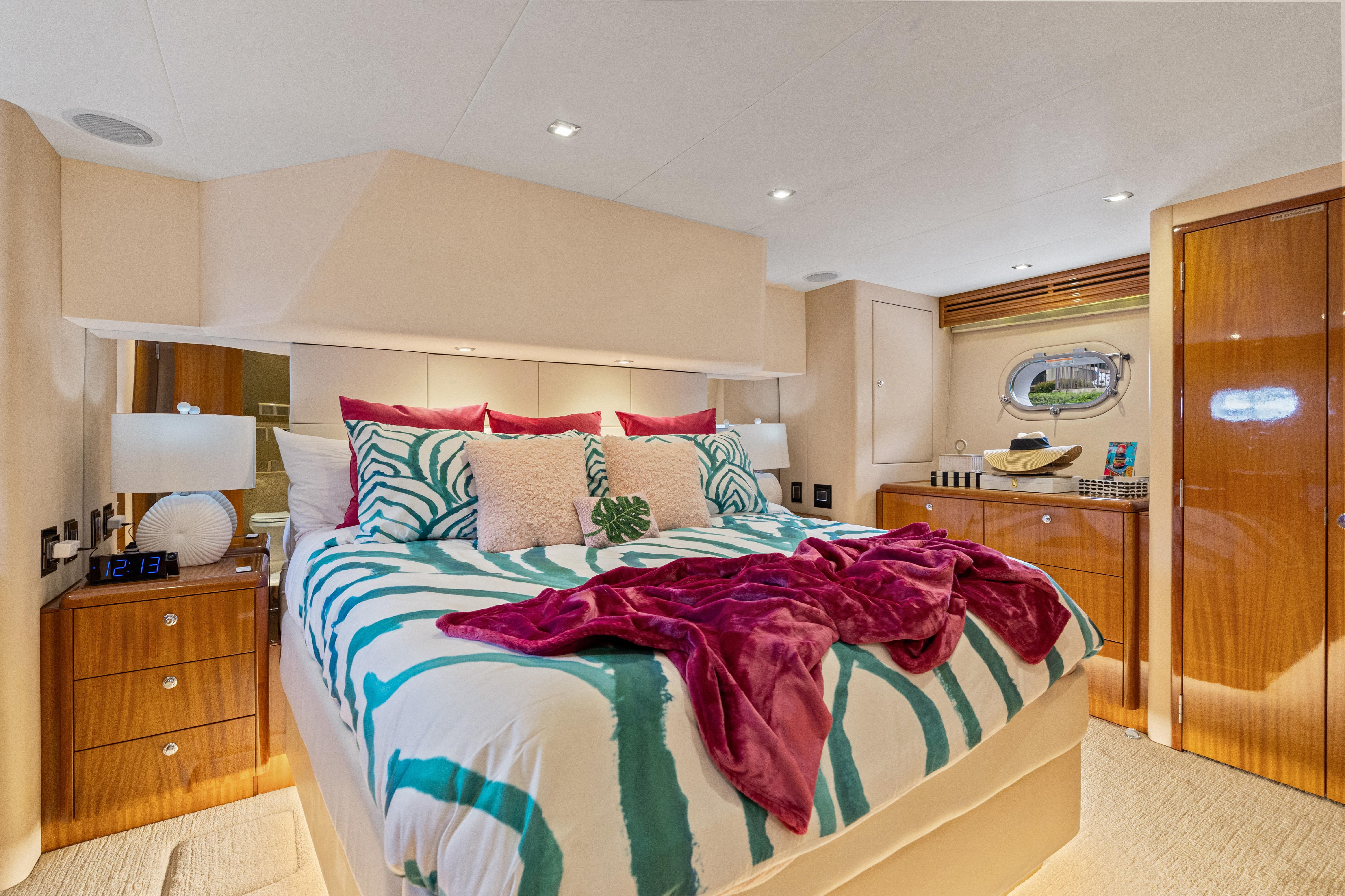 Luxurious bedroom interior of 2008 Hatteras 64 Motor Yacht with stylish decor and cozy bedding.