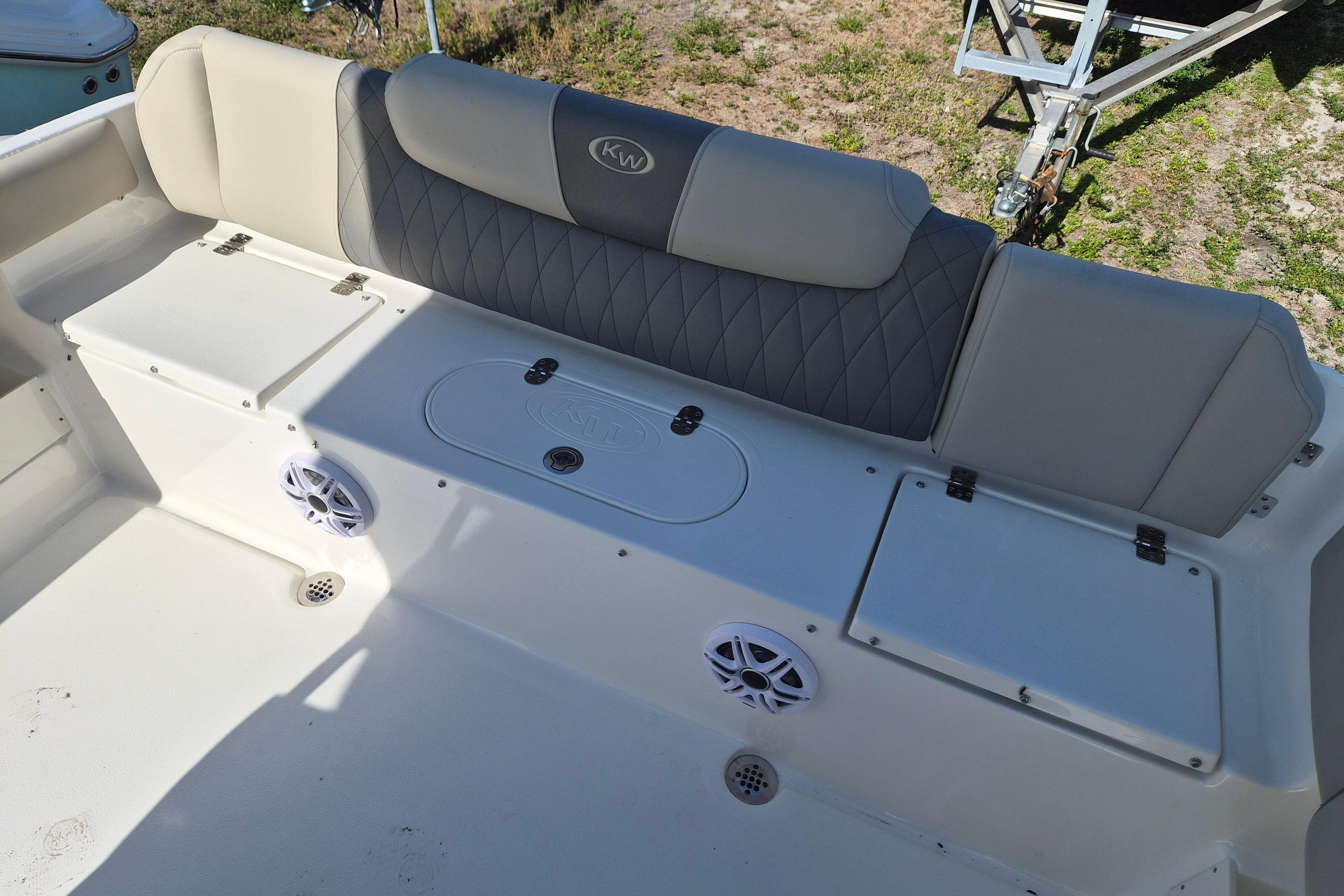 2026 Key West 239 FS boat interior with cushioned seating and storage compartments.