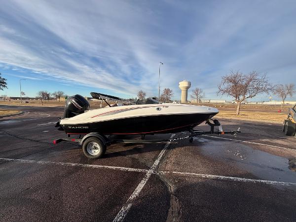 2023 Tahoe T16 boat on trailer in parking lot under cloudy sky.