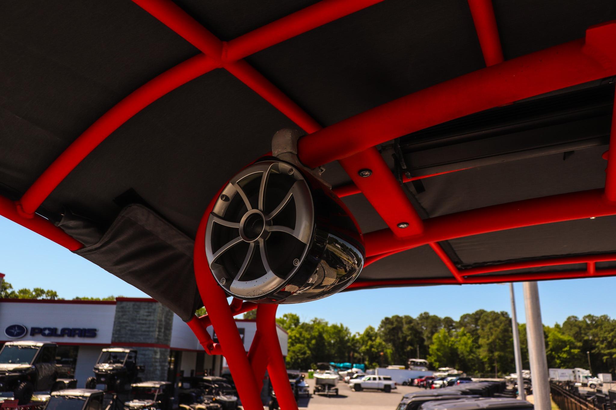Red frame and speaker on 2020 Yamaha Boats 242X, outdoor dealership setting.