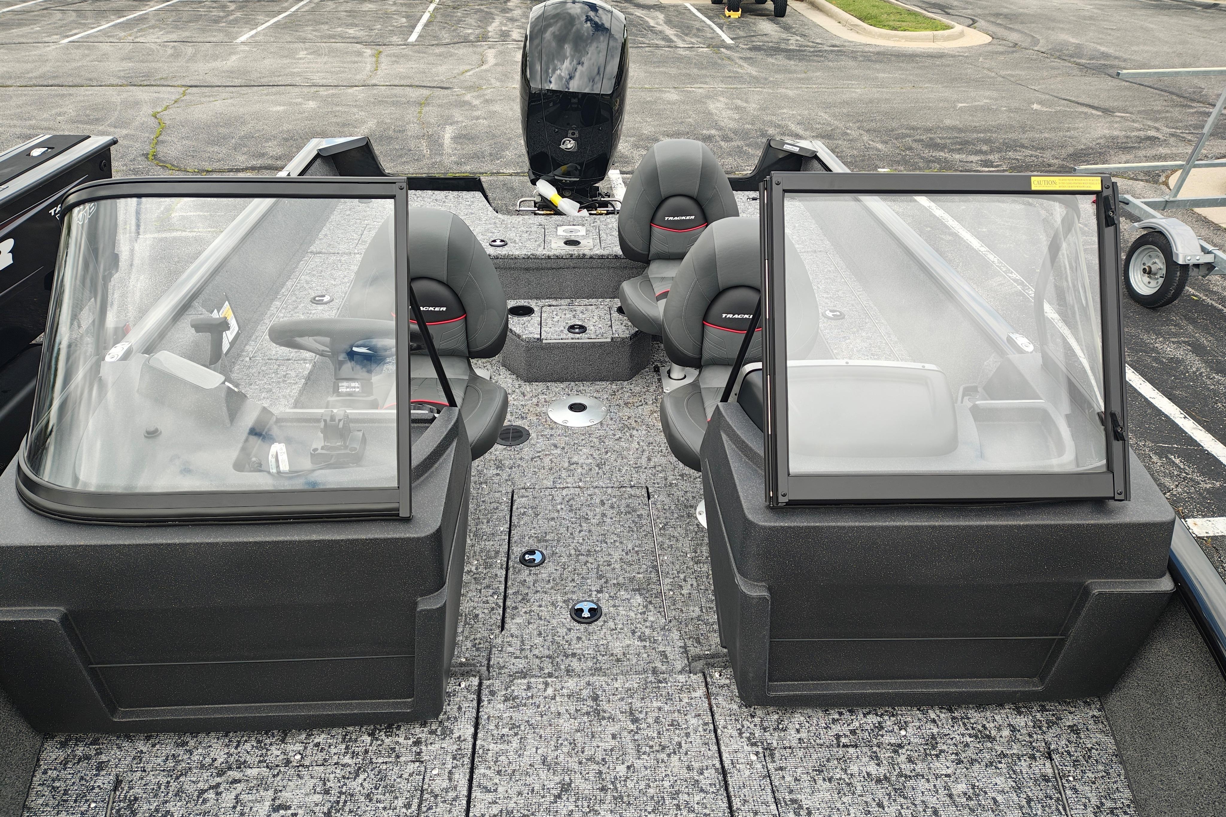 2026 Tracker Pro Guide V-175 WT boat interior with seating and windshield in a parking lot.