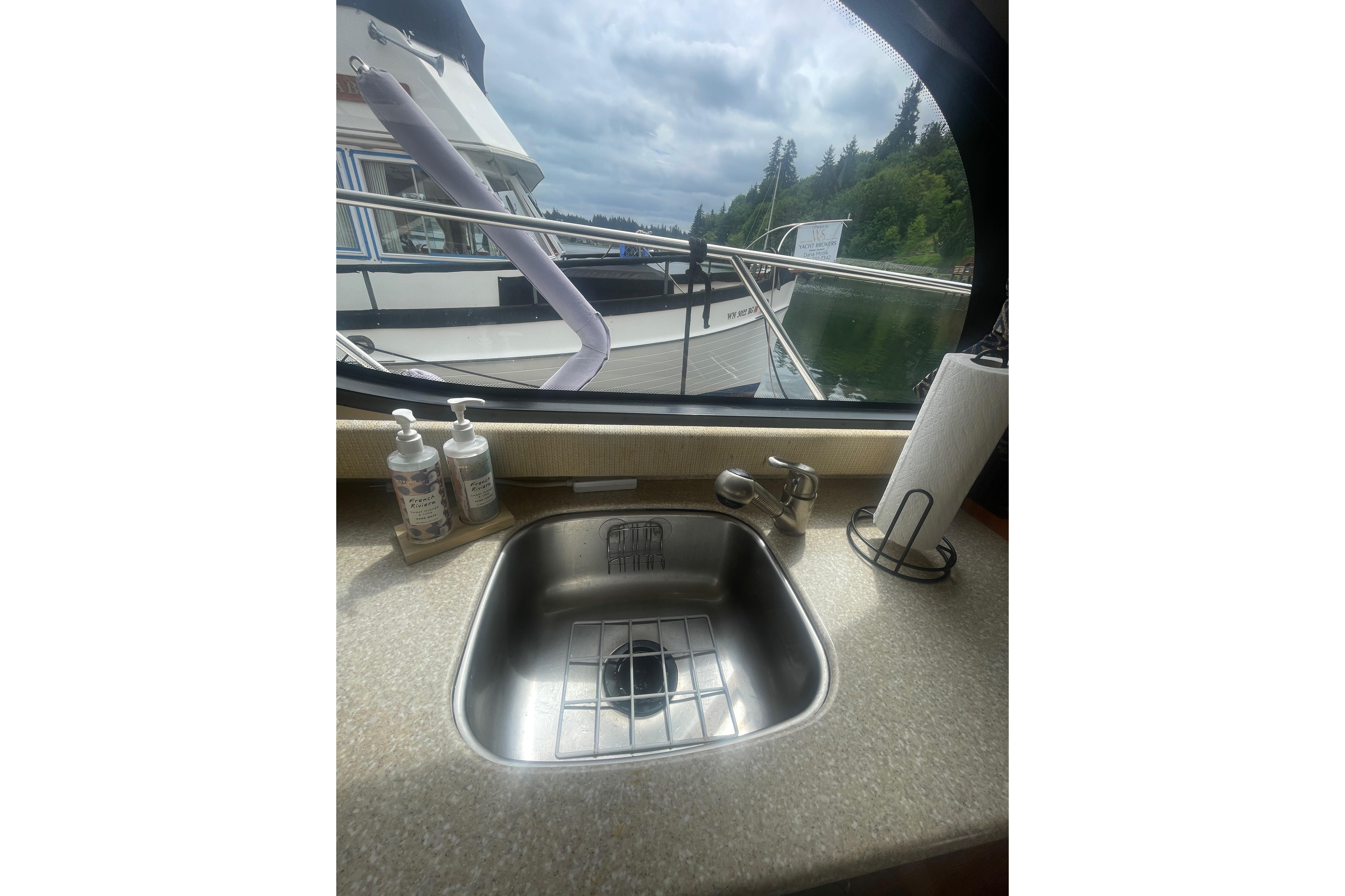Interior view of a 2004 Meridian 341 Sedan yacht kitchen sink with window view.