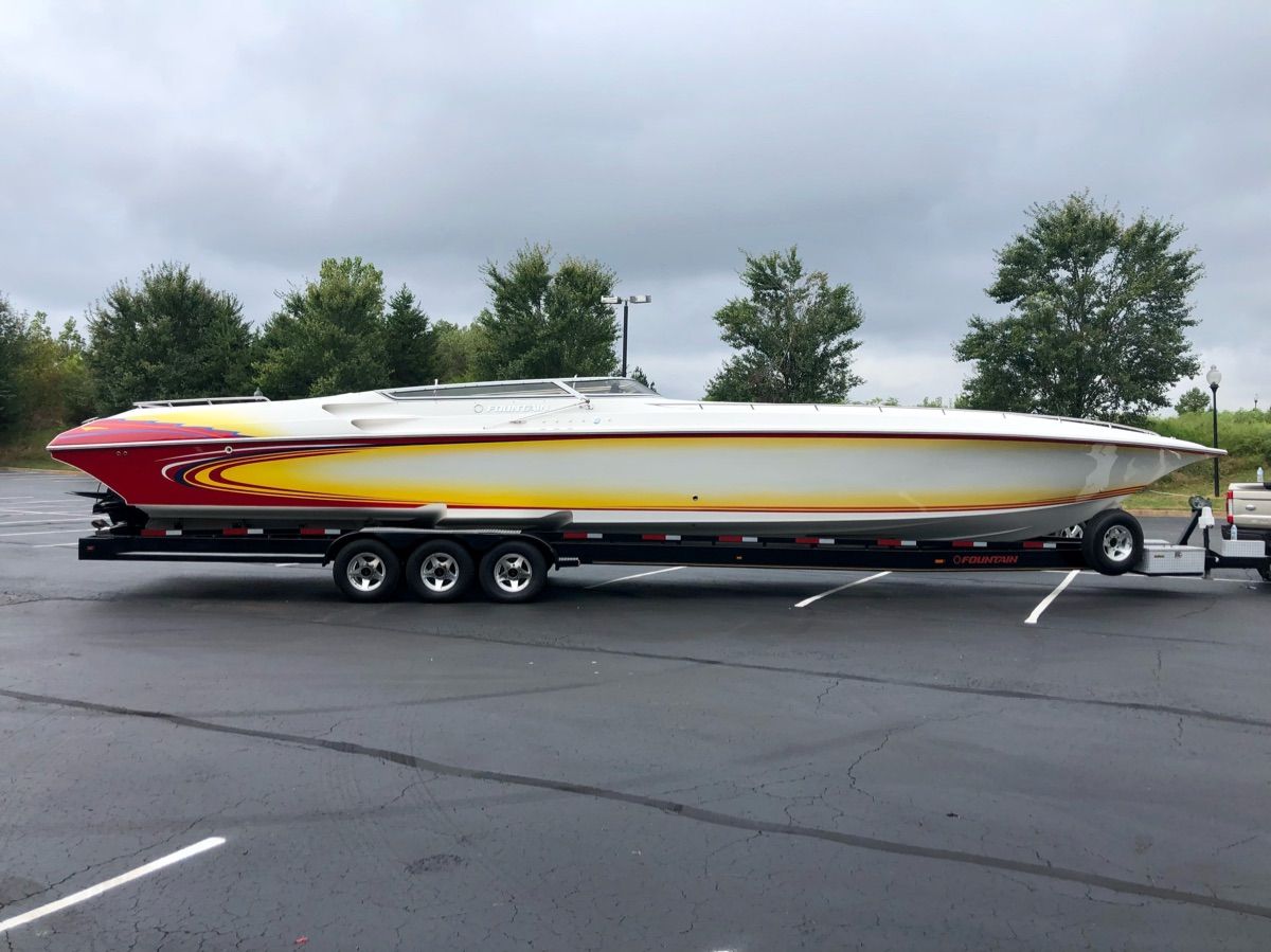 A 2005 Fountain 47 Lightning on a trailer in a parking lot.