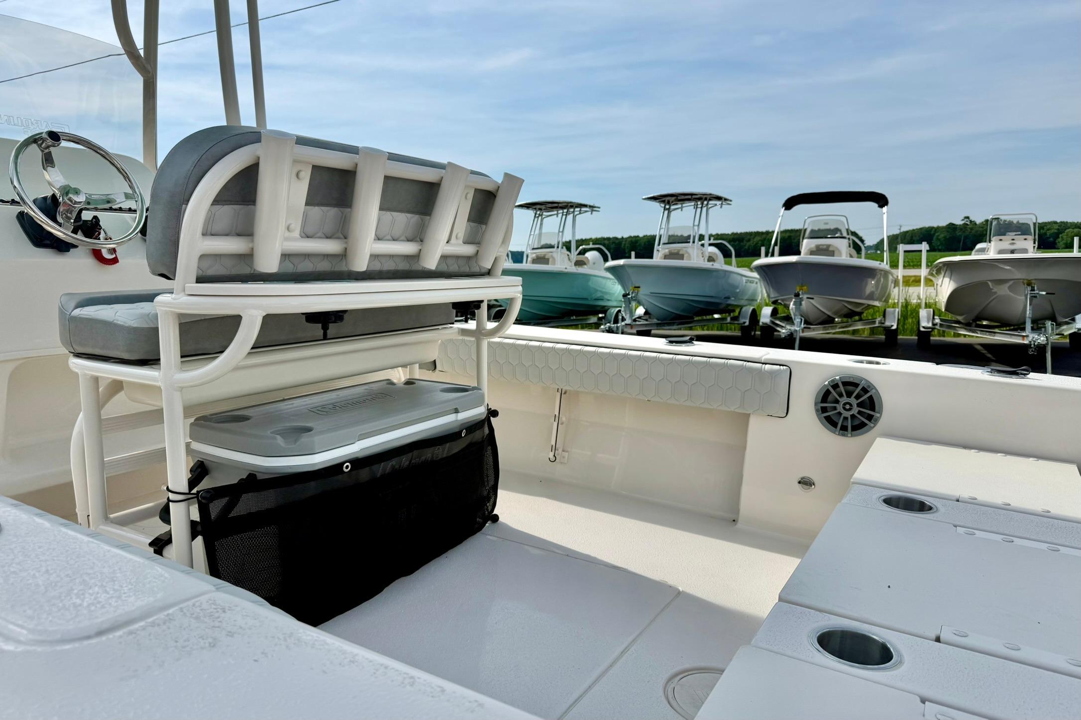 2026 Carolina Skiff 24 Ultra Elite boat interior with seating and storage, surrounded by other boats.